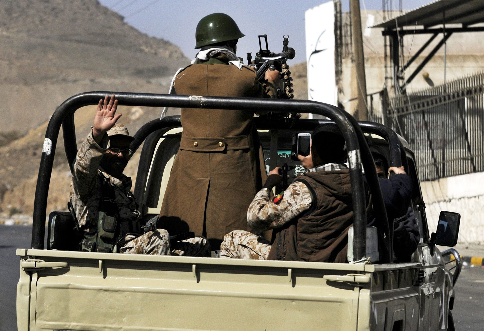 Members of the Houthi militia patrol streets near the Presidential Palace, Sana'a, Yemen, 20 January 2015