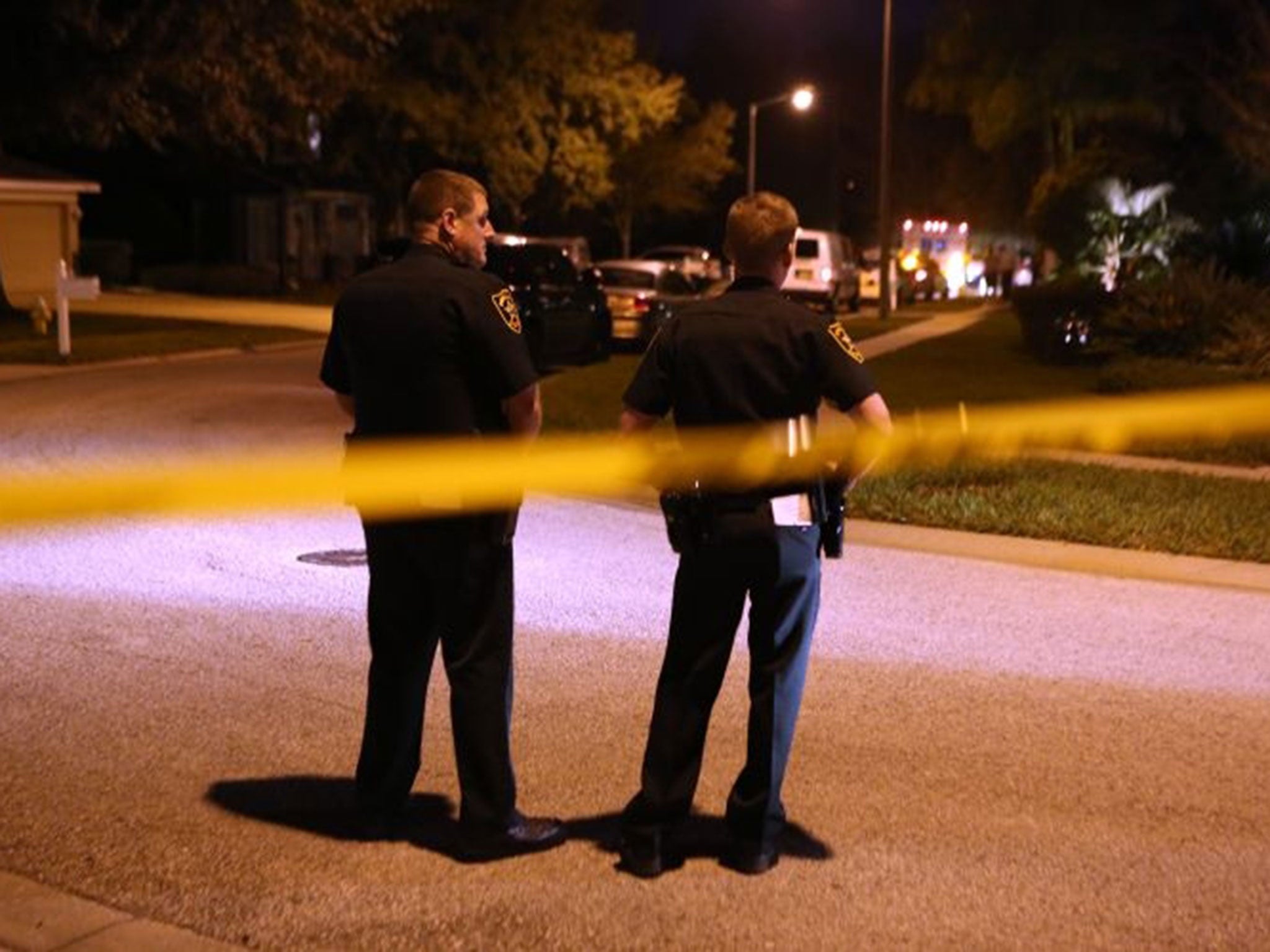 Police stand guard near an East Lake, Fla., home, where authorities say a two-year-old child died from an apparent self-inflicted gunshot wound.