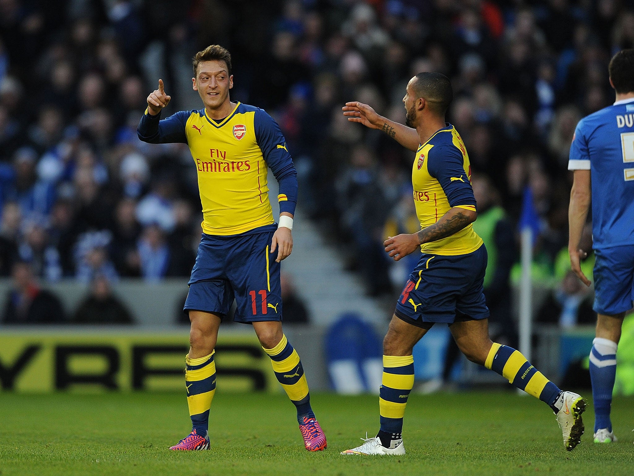 Mesut Ozil (left) celebrates his goal with Walcott