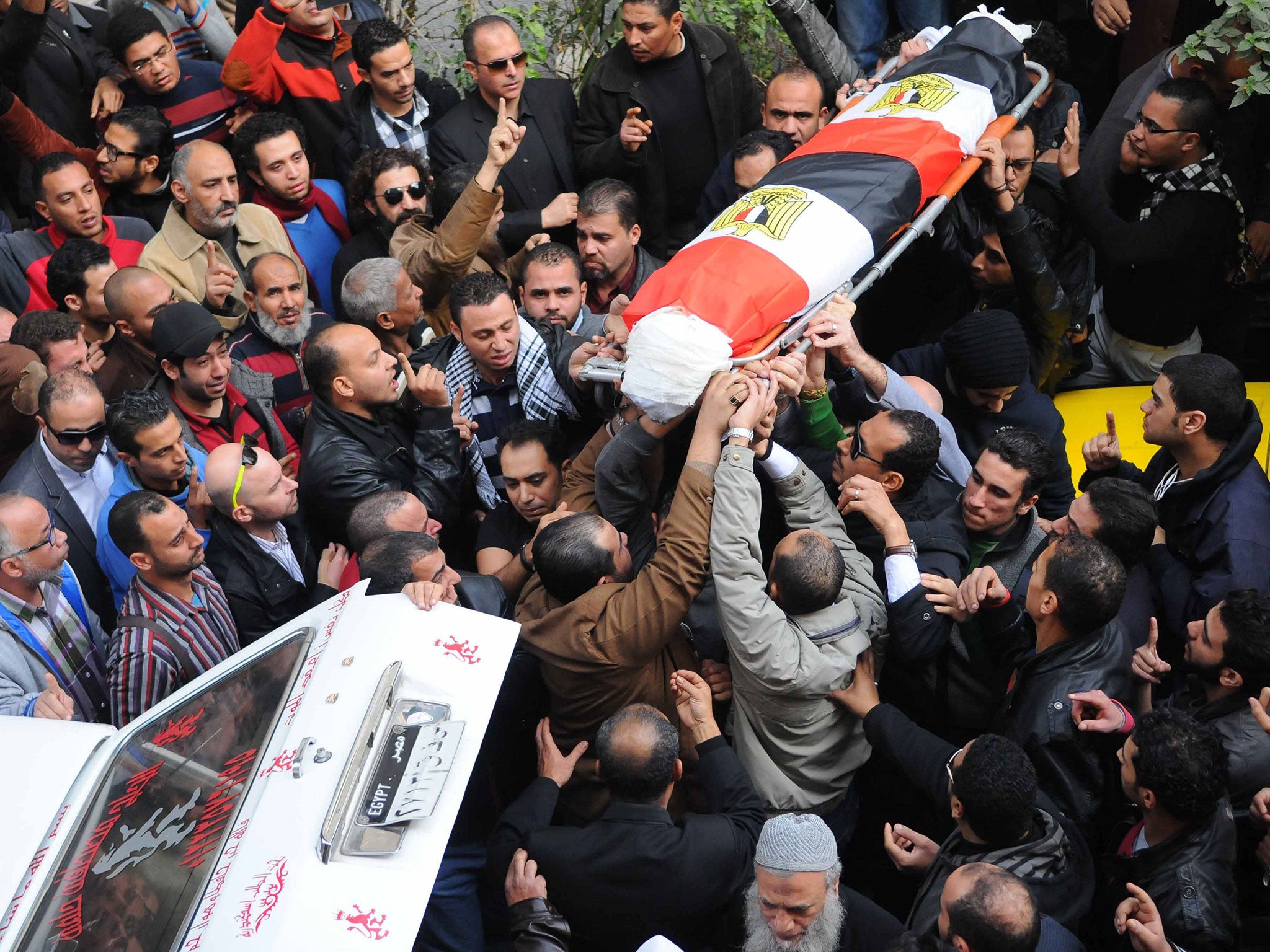 People carry the coffin of Shaima al-Sabbagh during her funeral, Alexandria, Egypt, 25 January 2015