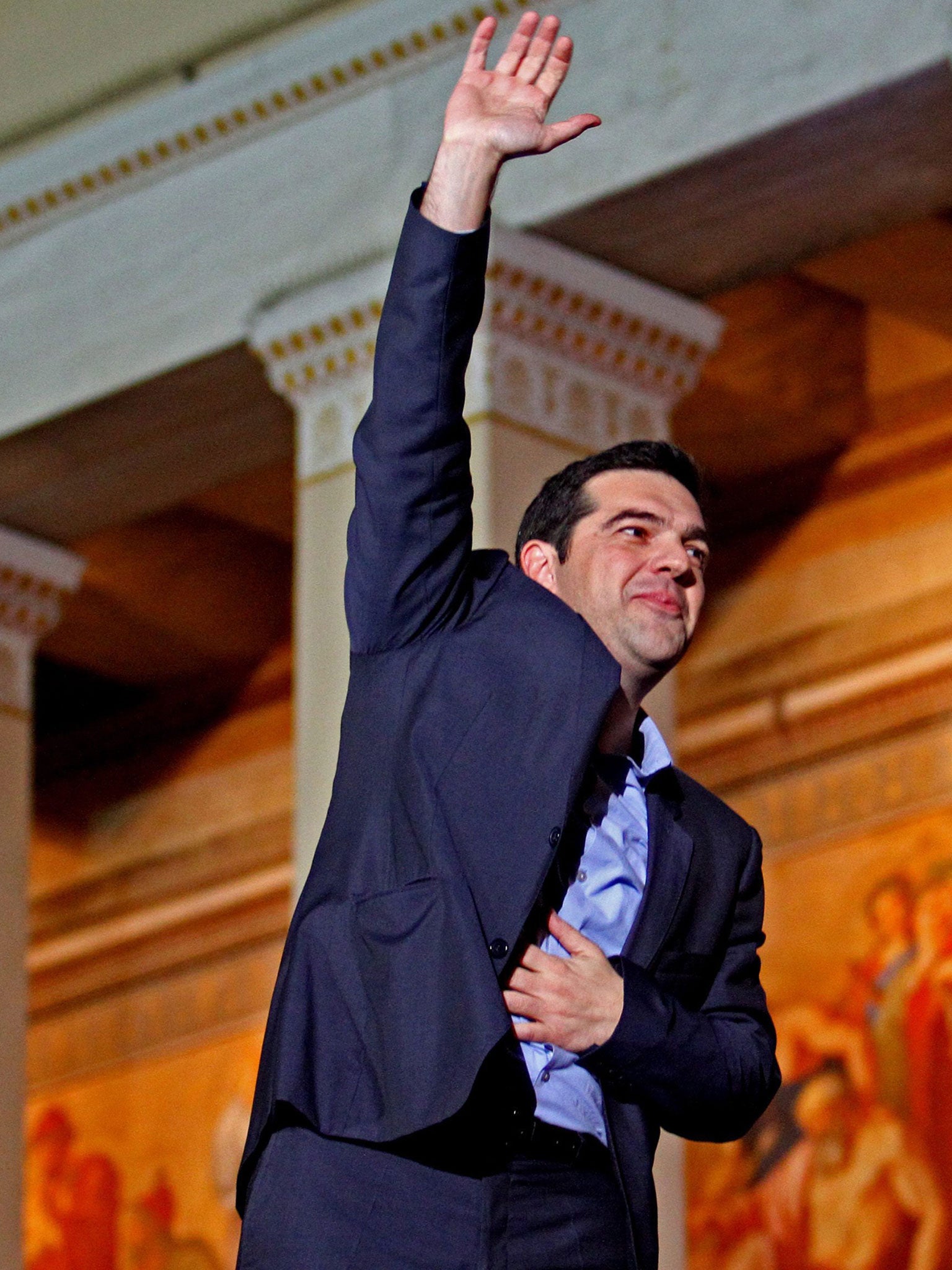 Alexis Tsipras, opposition leader and head of radical leftist Syriza party, greets supporters after the initial election results for the Greece general elections in Athens