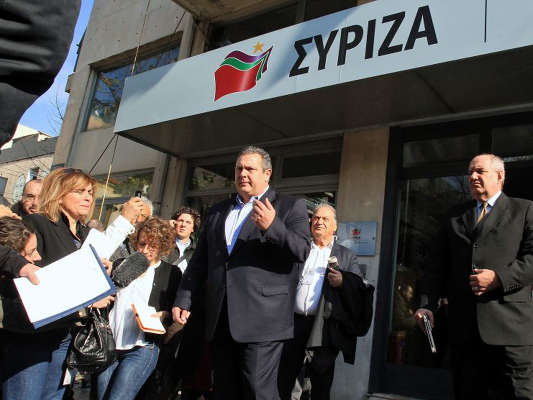 Panos Kammenos, the leader of the Independent Greeks party, speaks to journalists after leaving the Syriza party headquarters