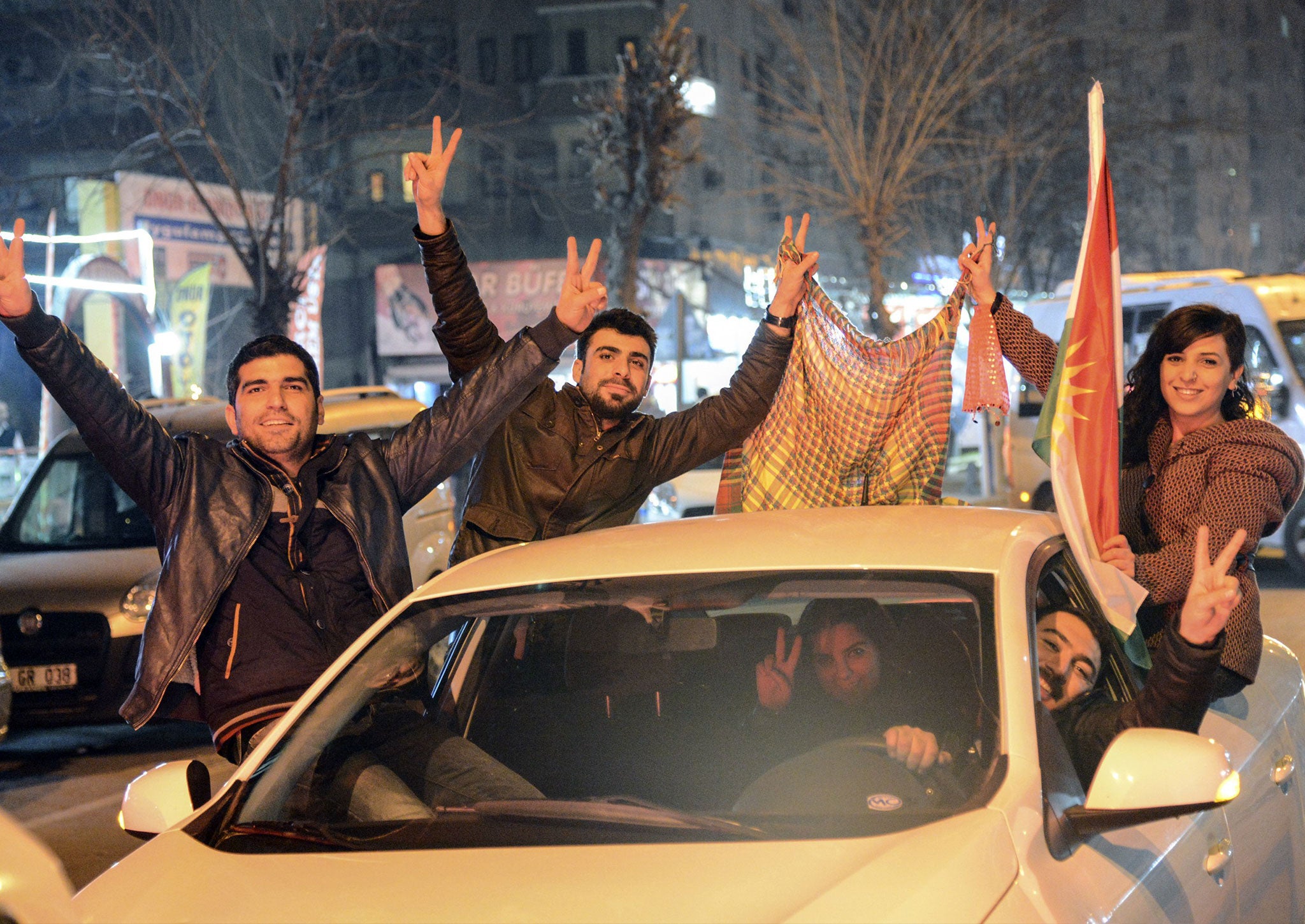 Kurds celebrate as they drive along a street in Diyarbakir, southeastern Turkey, on January 26, 2015