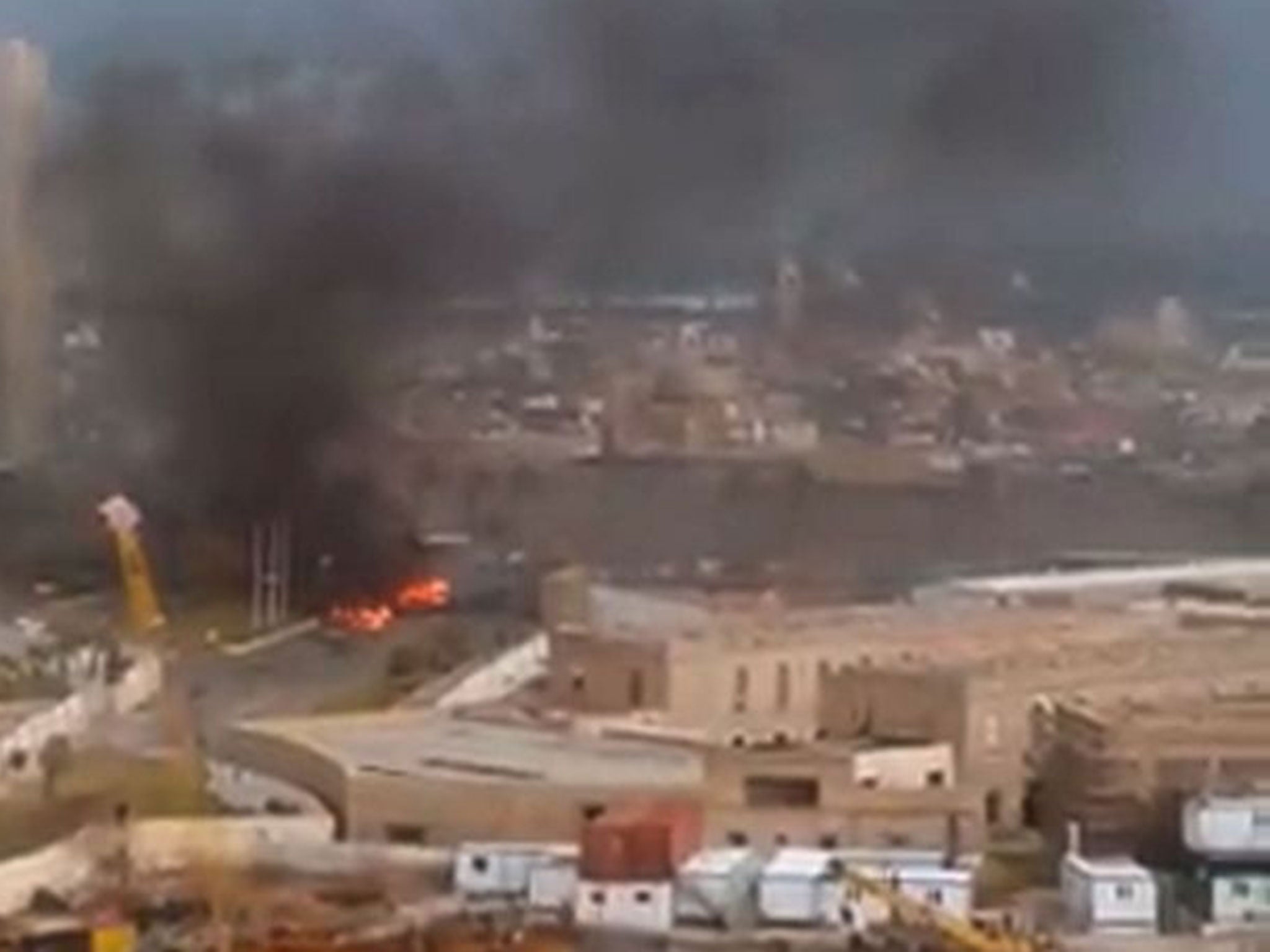 Fire and smoke rising in front of the Corinthia hotel in Tripoli on January 27, 2015 after gunmen stormed the luxury hotel.