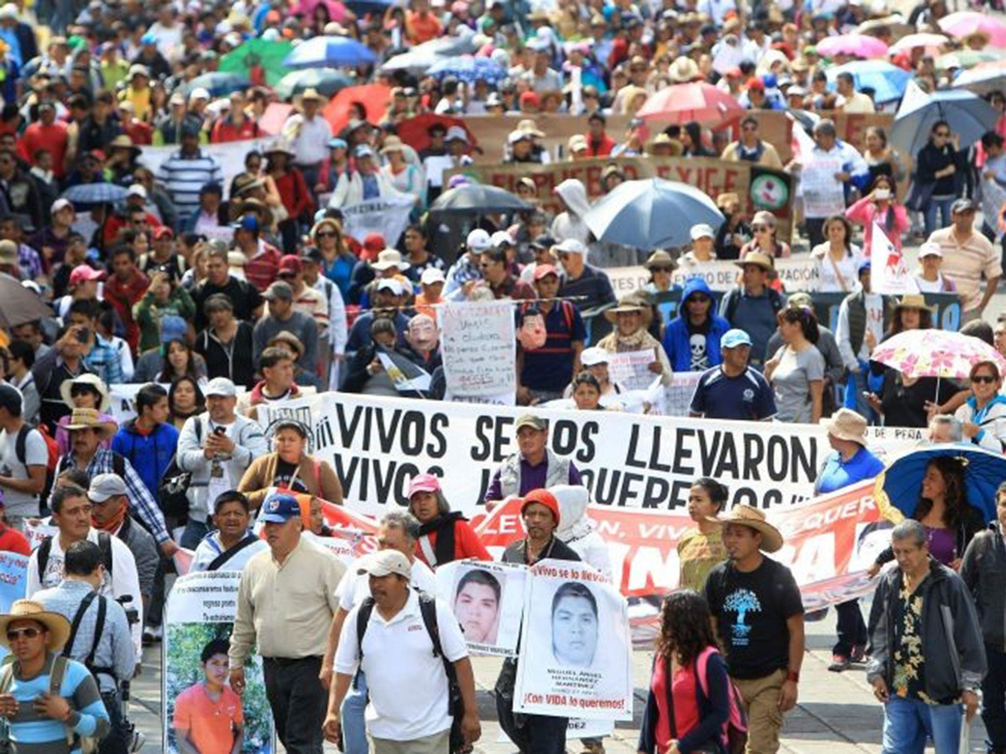 Parents of the 43 students missing in Iguala, Guerrero, accompanied by thousands of supporters, march to commemorate the fourth month since their disappearance, in Mexico City on 26 January