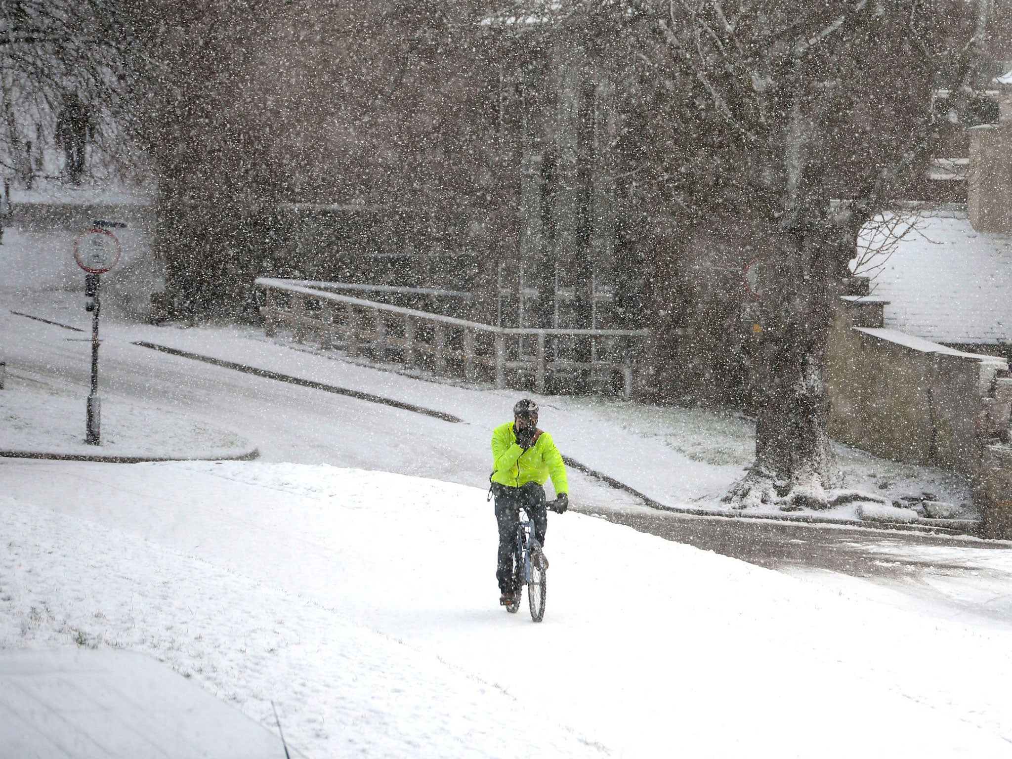 A cyclist makes his way through a blizzard in Durham