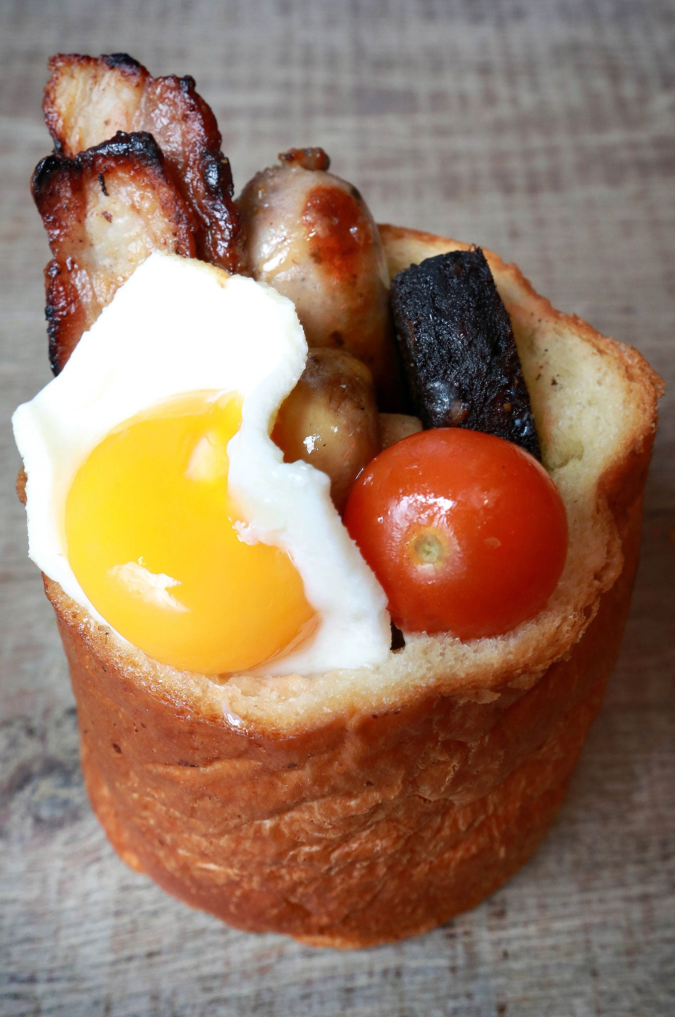 The Full English Bunny - an individually baked brioche loaf hollowed out and filled with sausage, lean bacon, tomatoes, mushrooms, spicy baked beans, black pudding and an egg