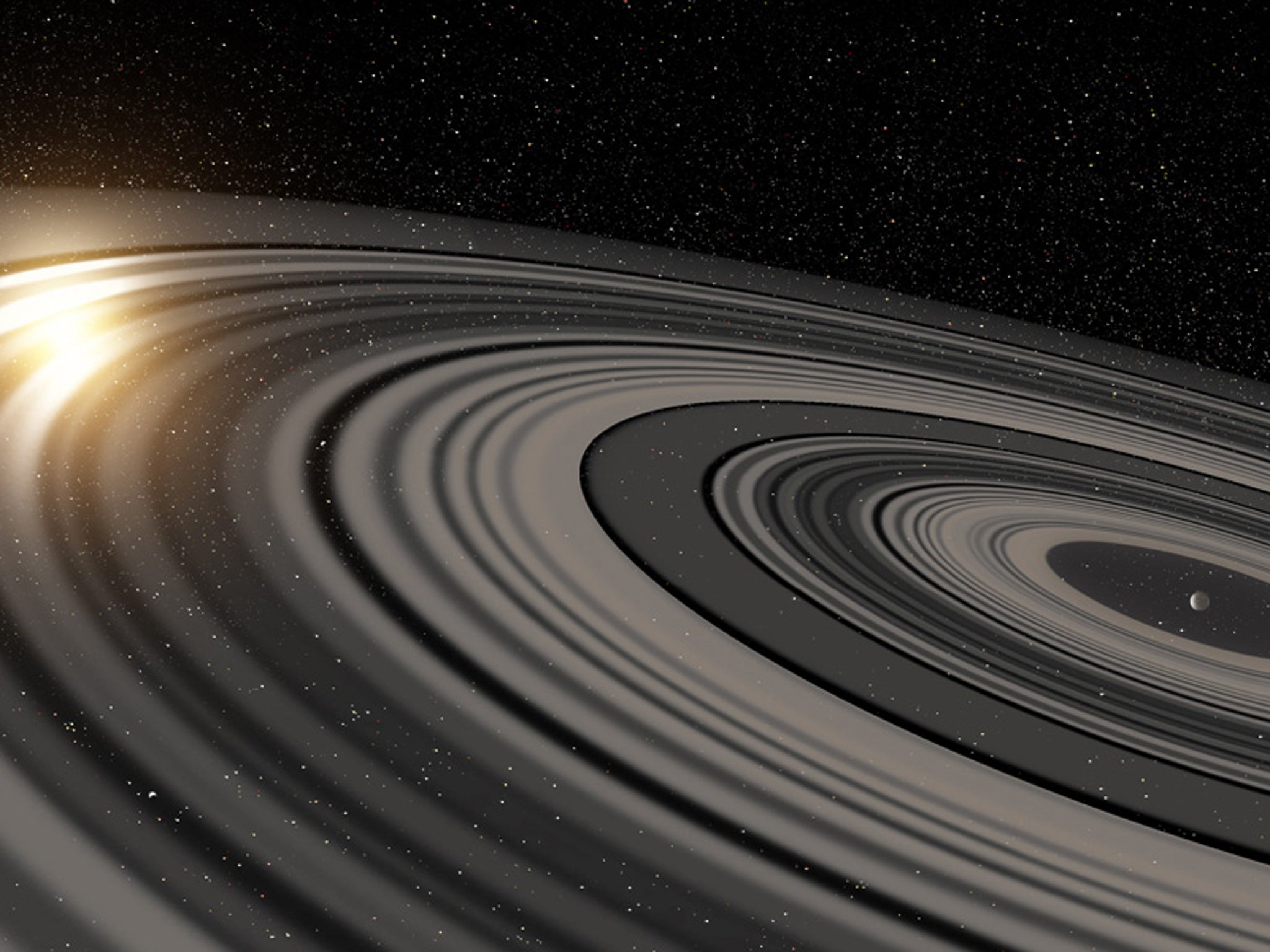 Artist’s conception of the extrasolar ring system circling the young giant planet or brown dwarf J1407b. The rings are shown eclipsing the young sun-like star J1407, as they would have appeared in early 2007