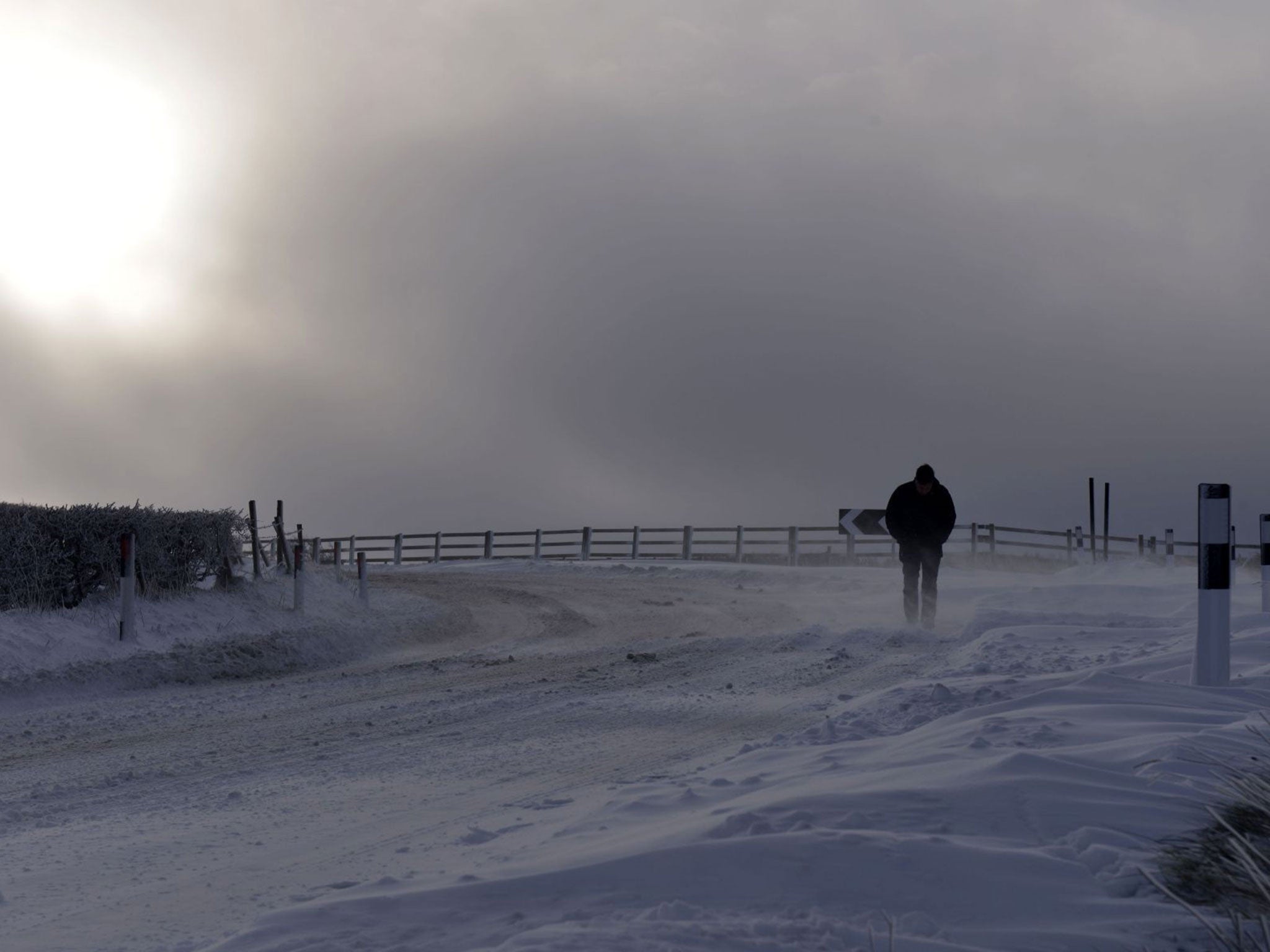 A stranded motorist makes his way over Dundrod on 29 January, in Northern Ireland