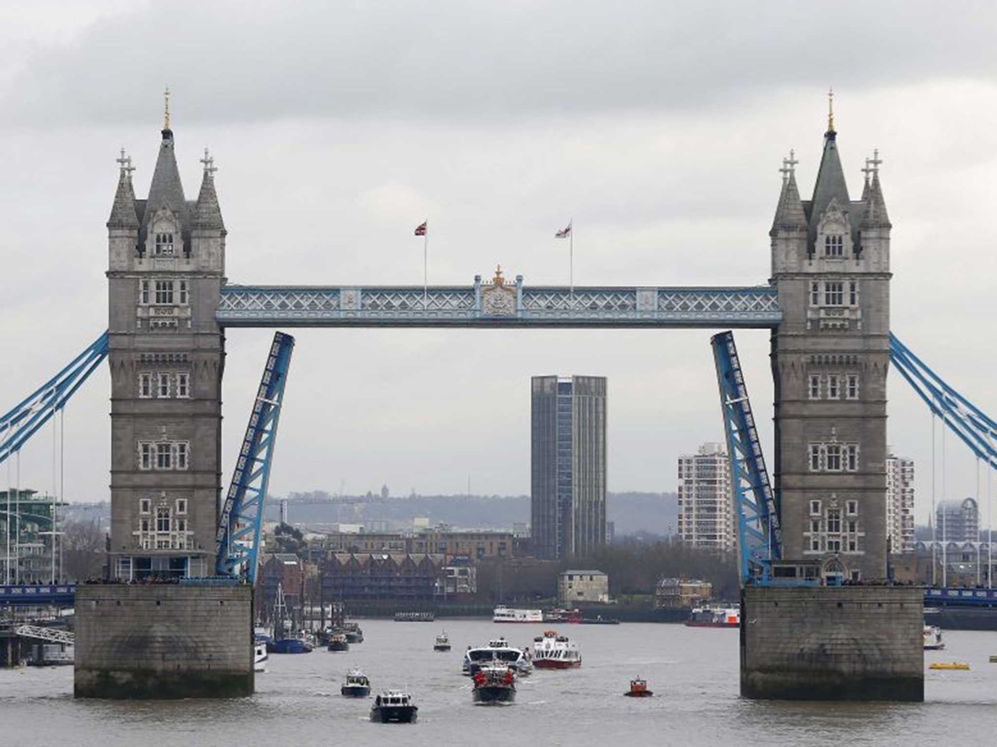 Tower Bridge opens as the Havengore passes through