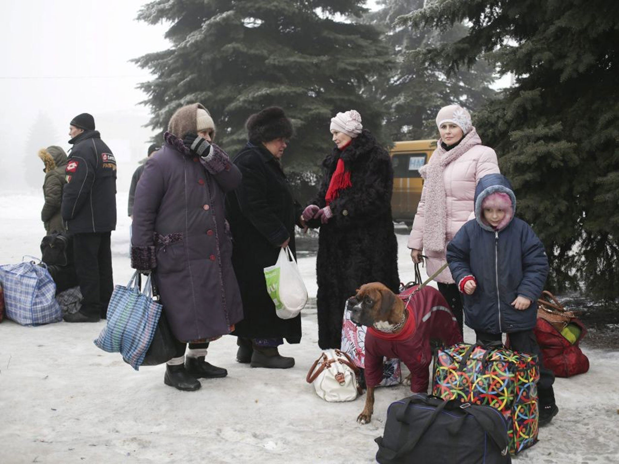 Families waiting for a bus to evacuate them from Debaltseve, Ukraine