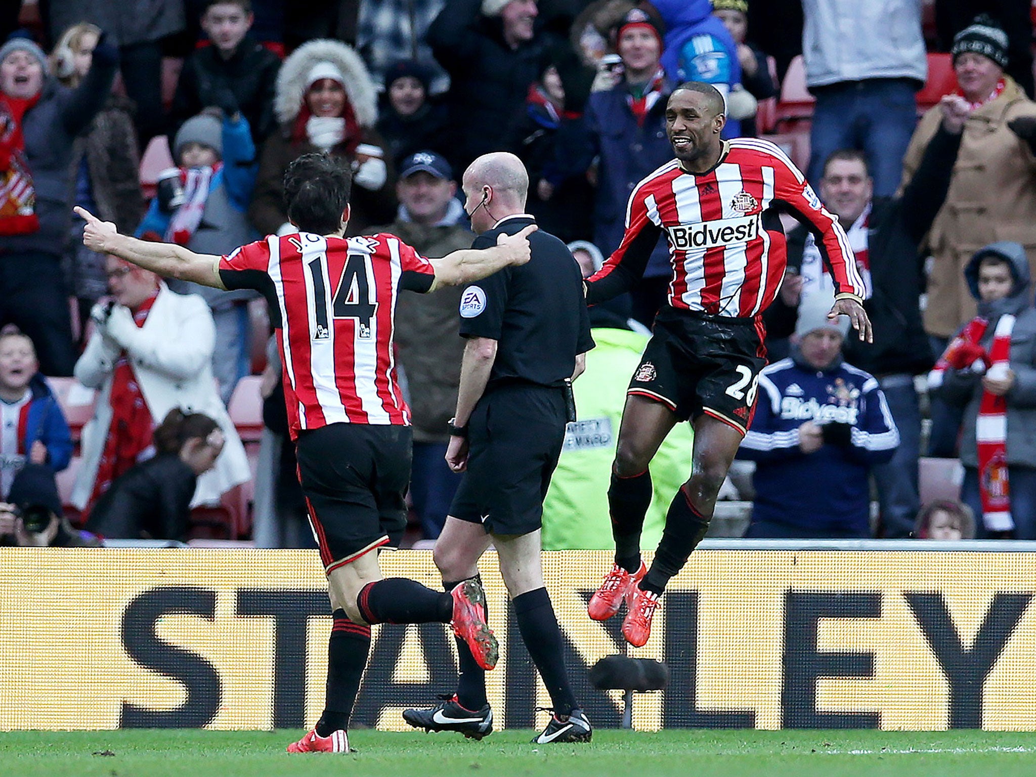 Jermain Defoe celebrates scoring his first goal for Sunderland with Jordi Gomez