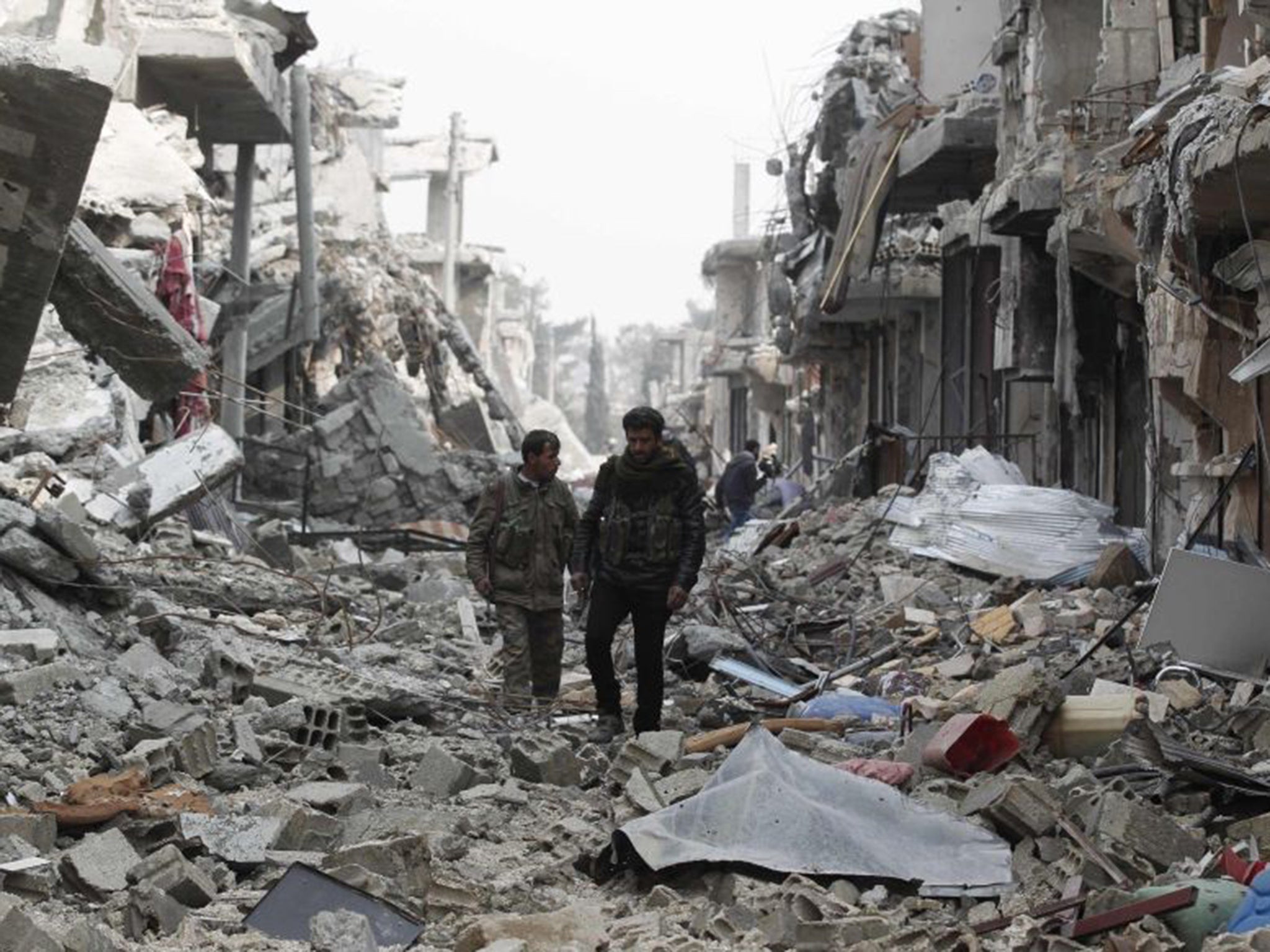 Fighters from the People’s Protection Units in the rubble of Kobani (Reuters)