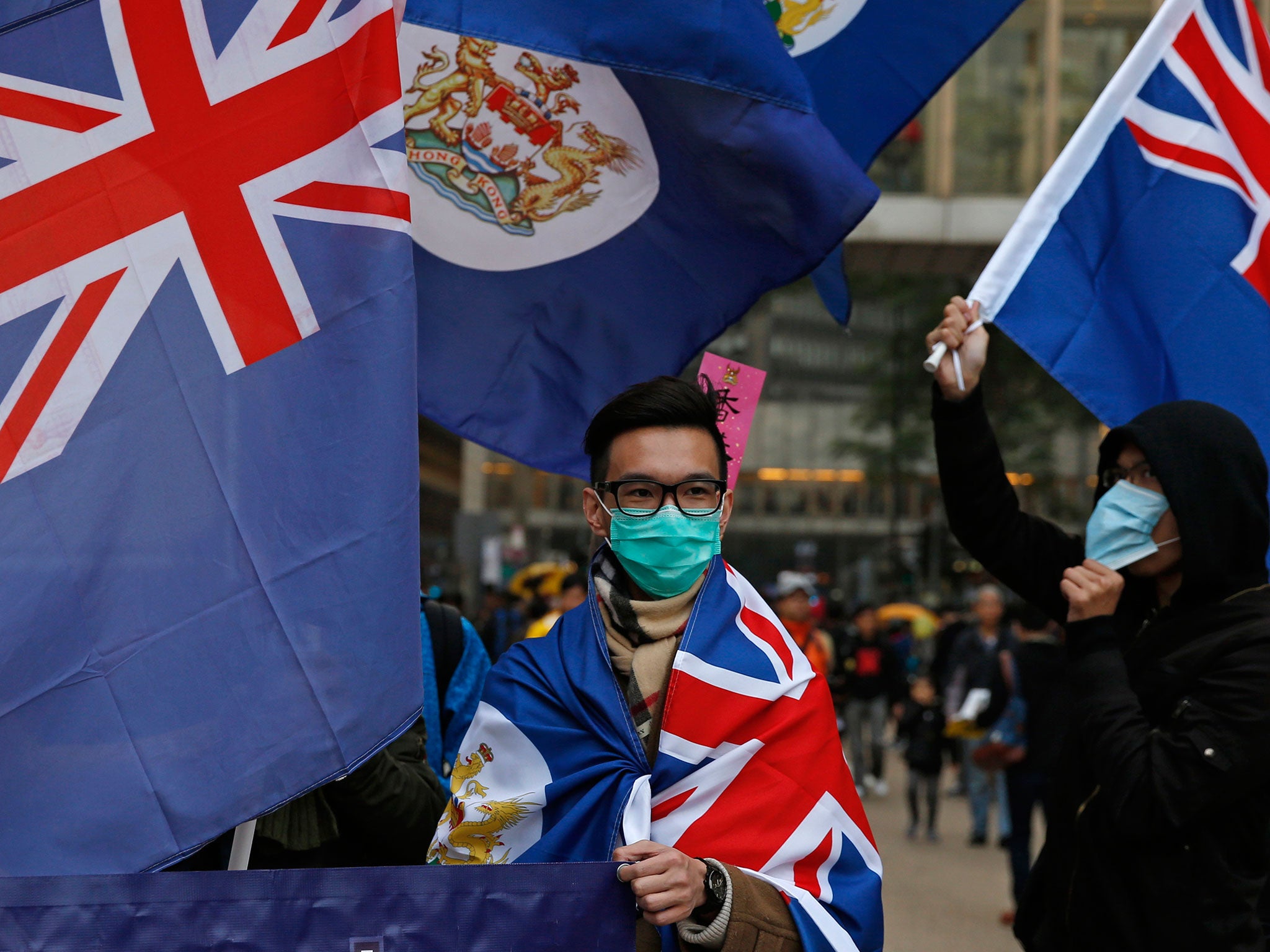 Activists wave the old colonial flag during the first large-scale protest since the 2014 occupations