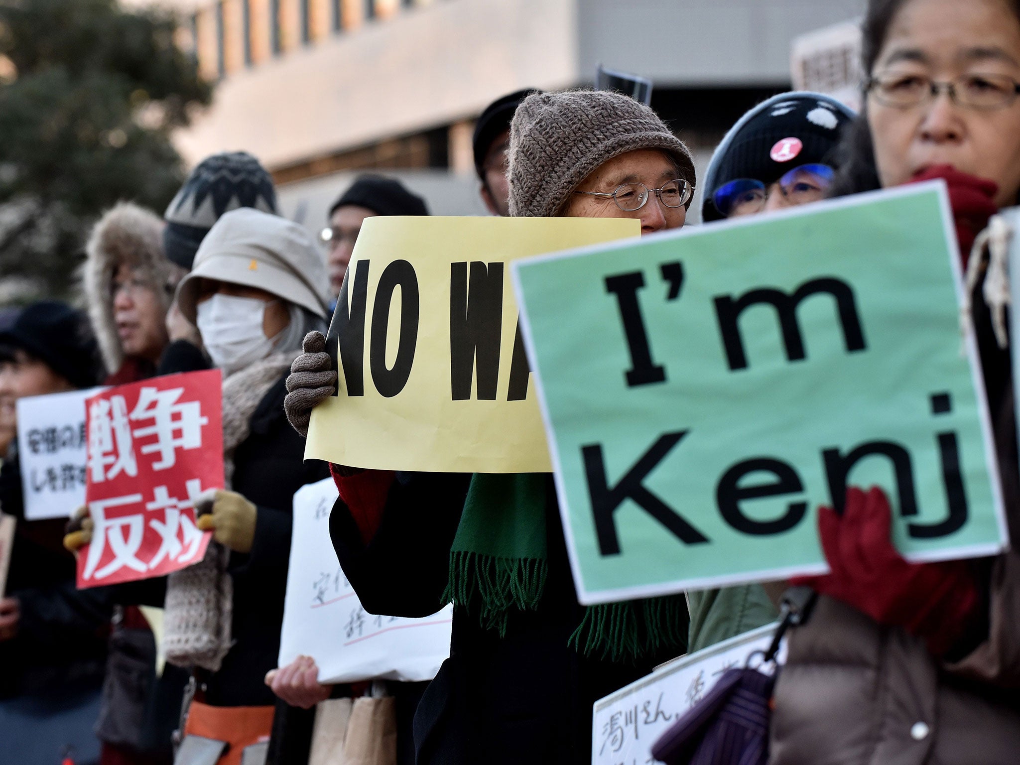 People stage a silent rally for Japanese hostage Kenji Goto, who was killed by the Islamic State group, near the prime minister's official residence in Tokyo