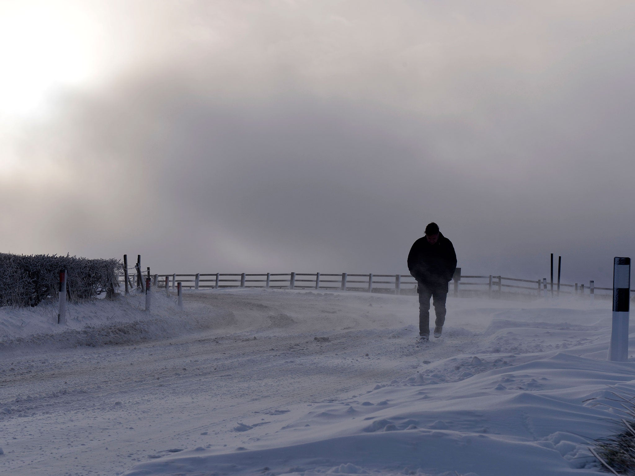 A stranded motorist makes his way through Dundrod in Northern Ireland