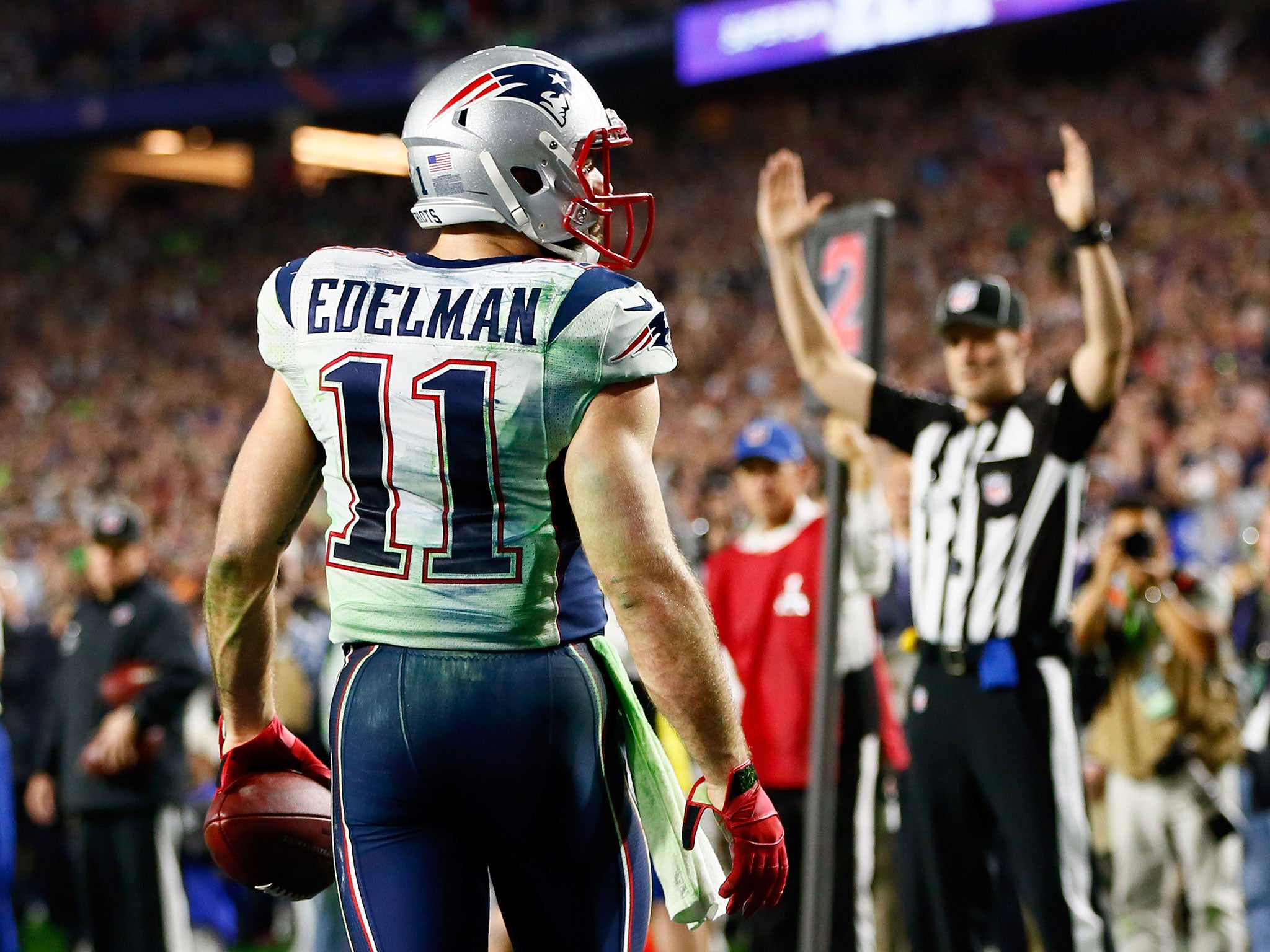 Julian Edelman demonstrates a prime example of the shoulder pads and bum protection used in the NFL