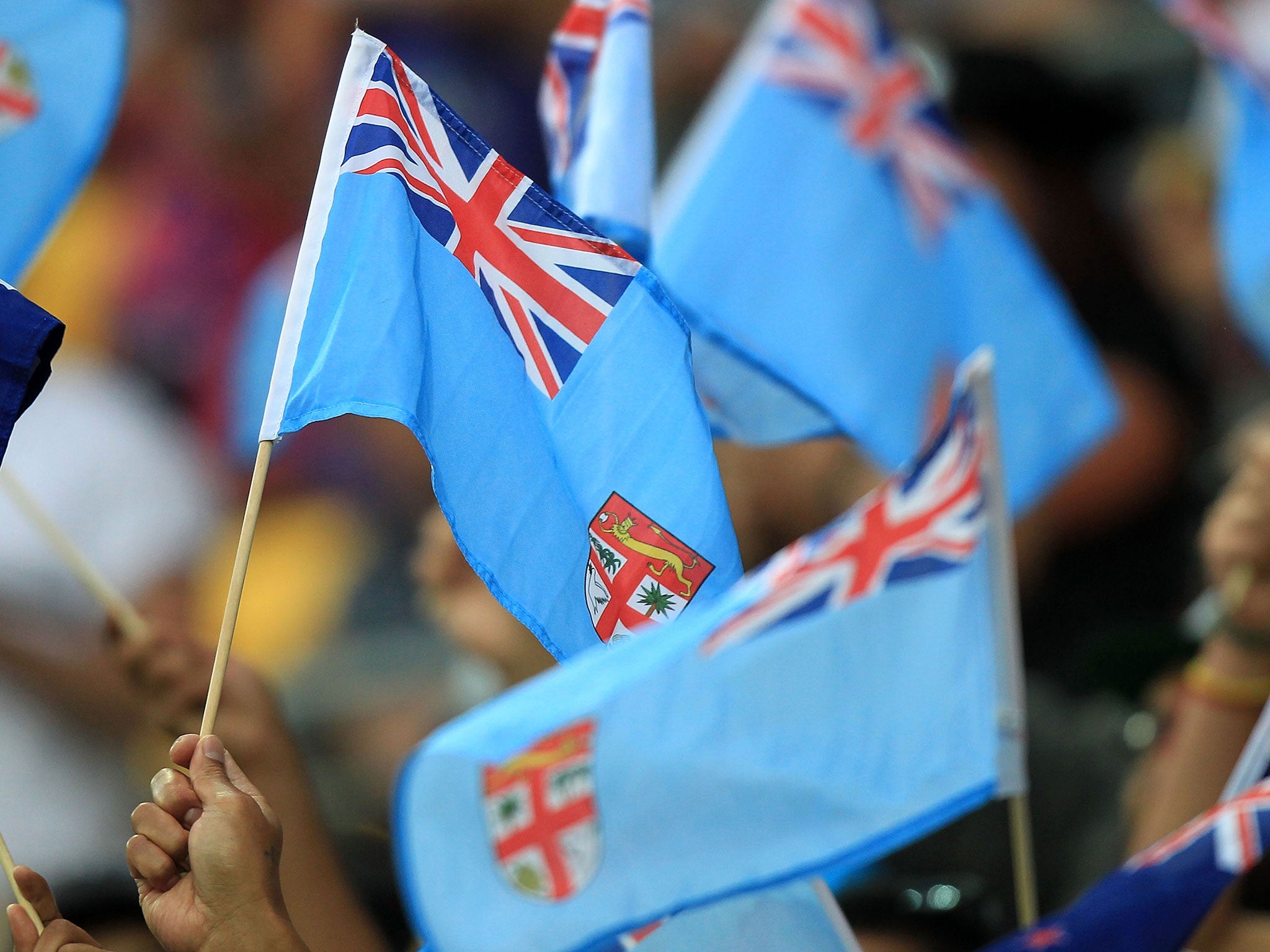 Fijian flags being waved during a rugby tournament