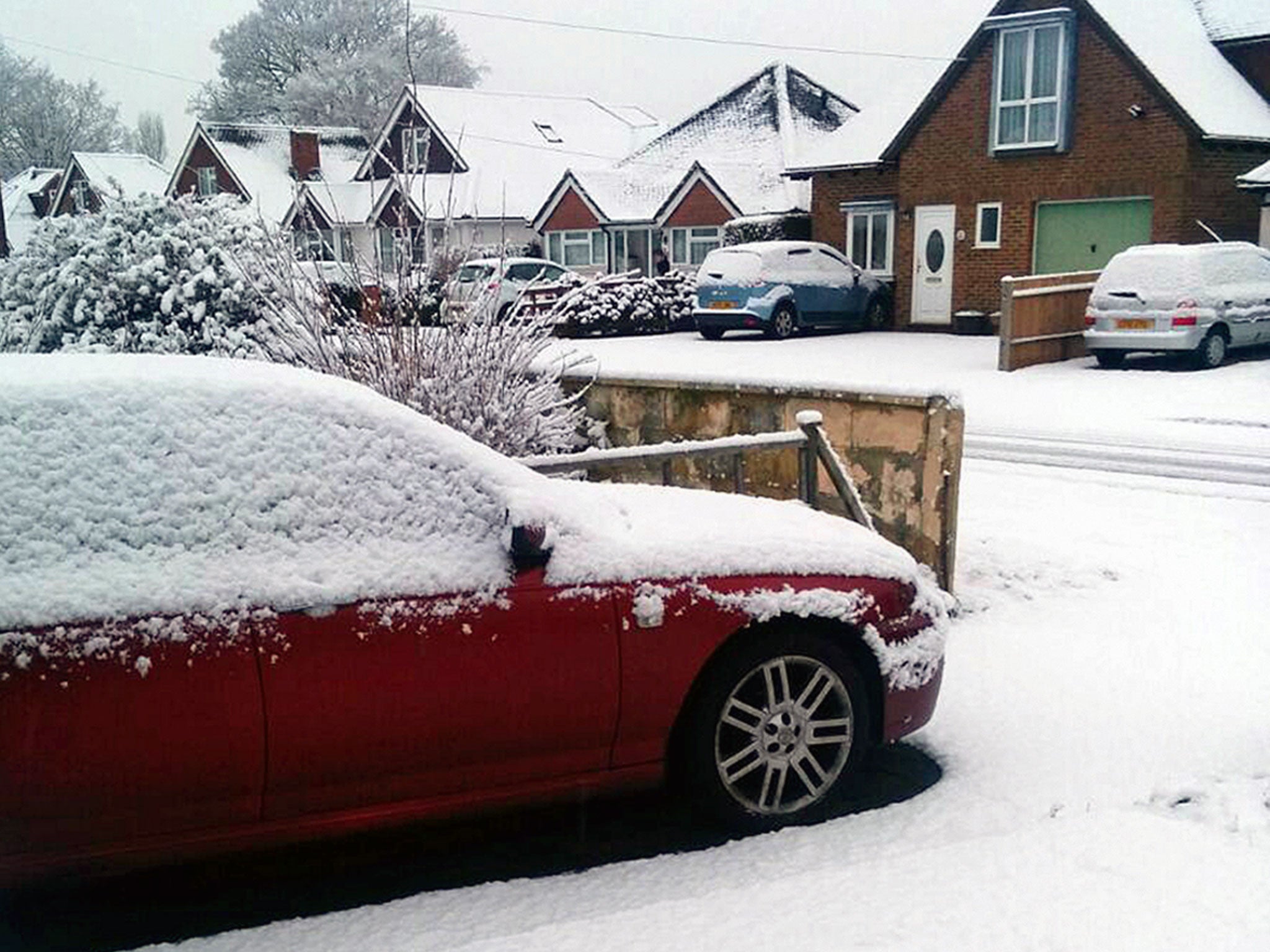 Heavy snow on a car in Farncombe, Surrey