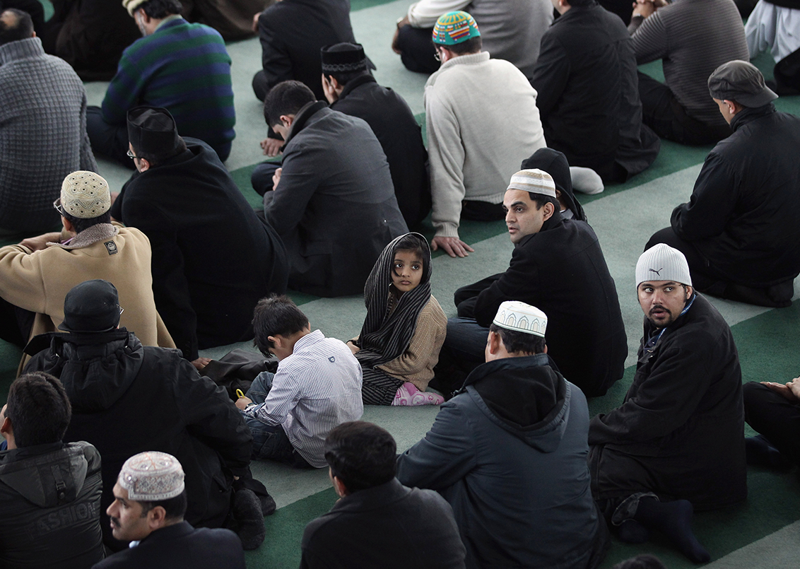 A young Muslim girl waits to pray with Muslim men at Baitul Futuh Mosque in Morden