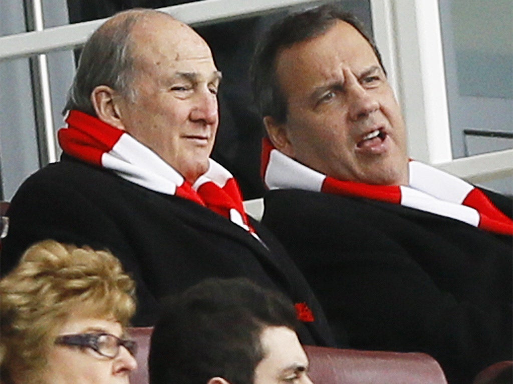 Chris Christie, right, sporting an Arsenal scarf as he watched the team's thrashing of Aston Villa at The Emirates on Sunday