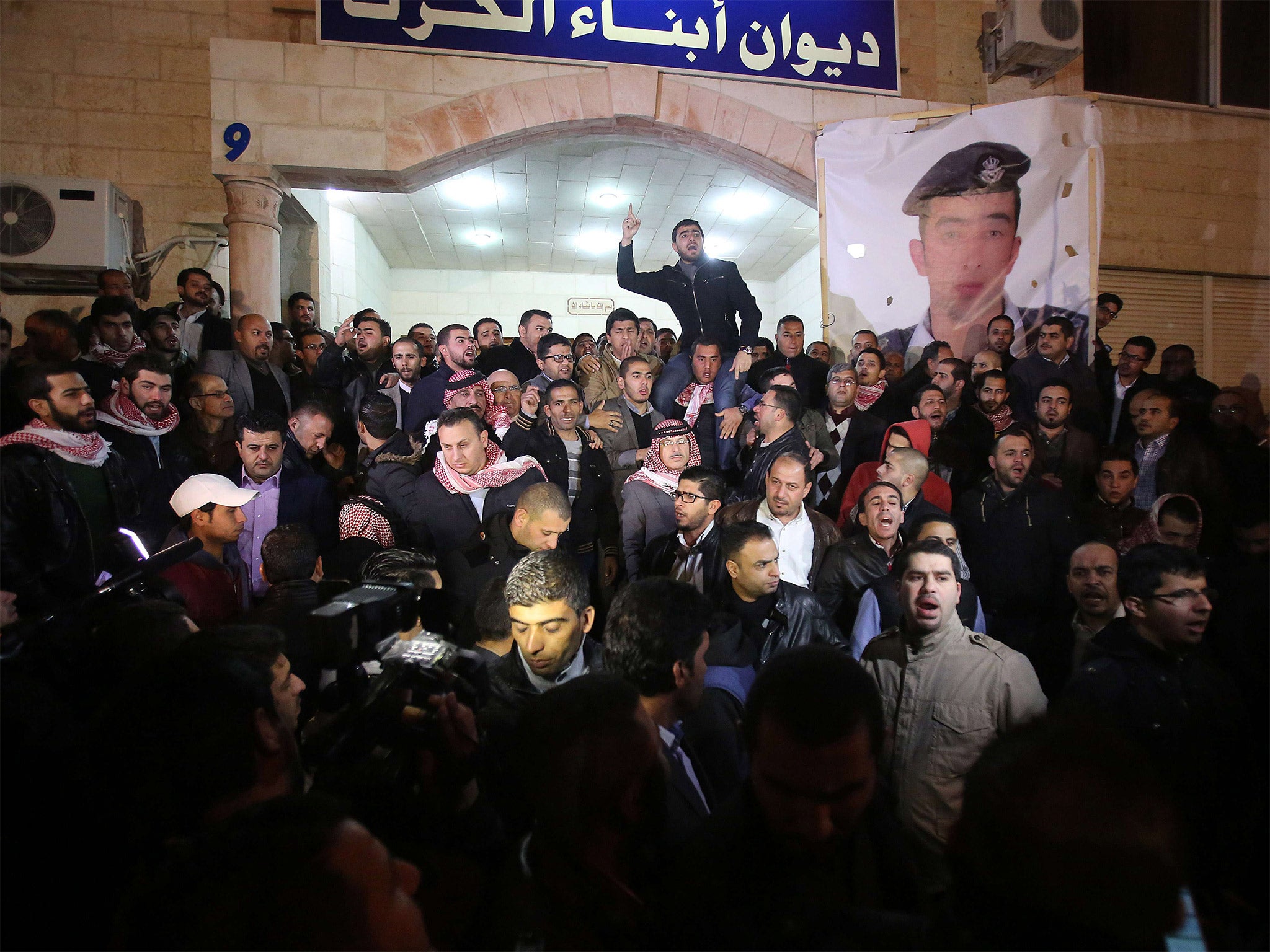 Supporters and family members of Jordanian pilot Lt. Muath al-Kaseasbeh express their anger at his murder at the tribal gathering chamber in Amman, Jordan (Getty)