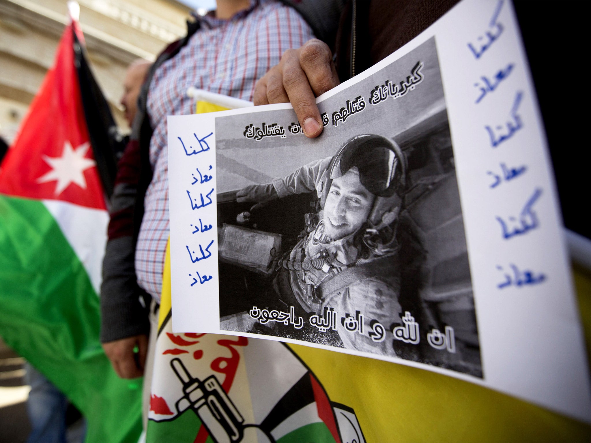 A Palestinian holds a poster of Lt Muath al-Kaseasbeh in front of
the Jordanian embassy in Ramallah