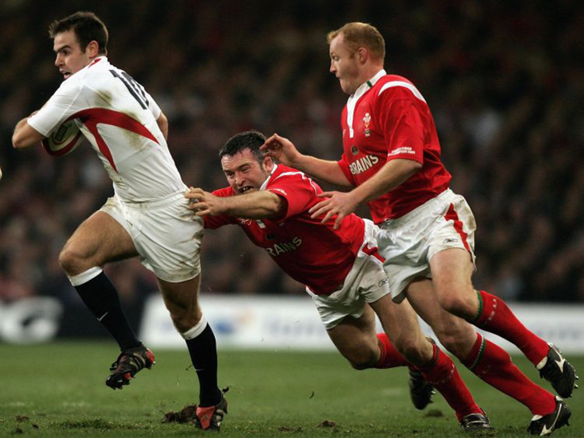 Martyn Williams (right) and Mefin Davies, of Wales, tackle Charlie Hodgson during the crucial defeat of England 10 years ago