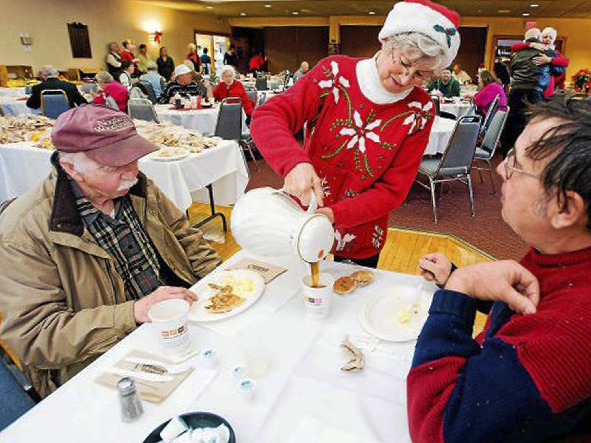 Connie Howe pours coffee for Ronald Read, left, and Dave Smith during the Charlie Slate Memorial Christmas breakfast at the American Legion in Brattleboro