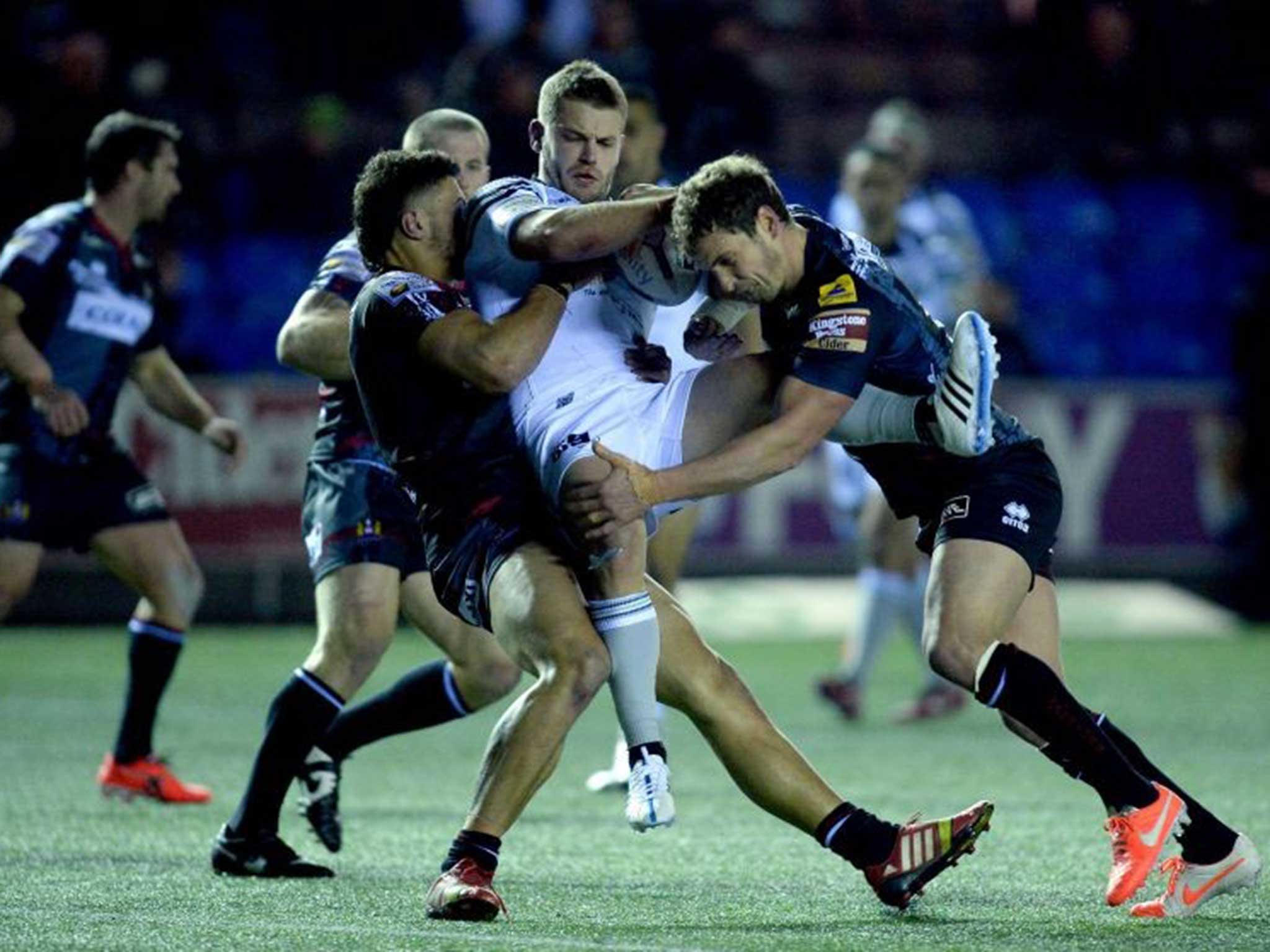 Widnes’ Rhys Hanbury is tacked by Anthony Gelling (left) and Sean O’Loughlin (right)