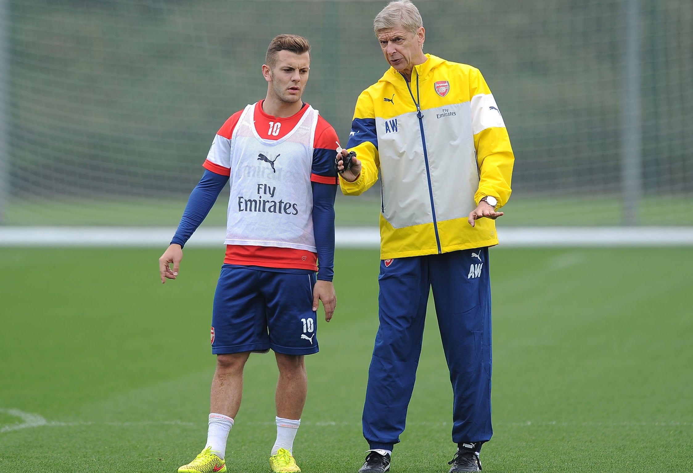 Arsene Wenger (right) speaks with Jack Wilshere