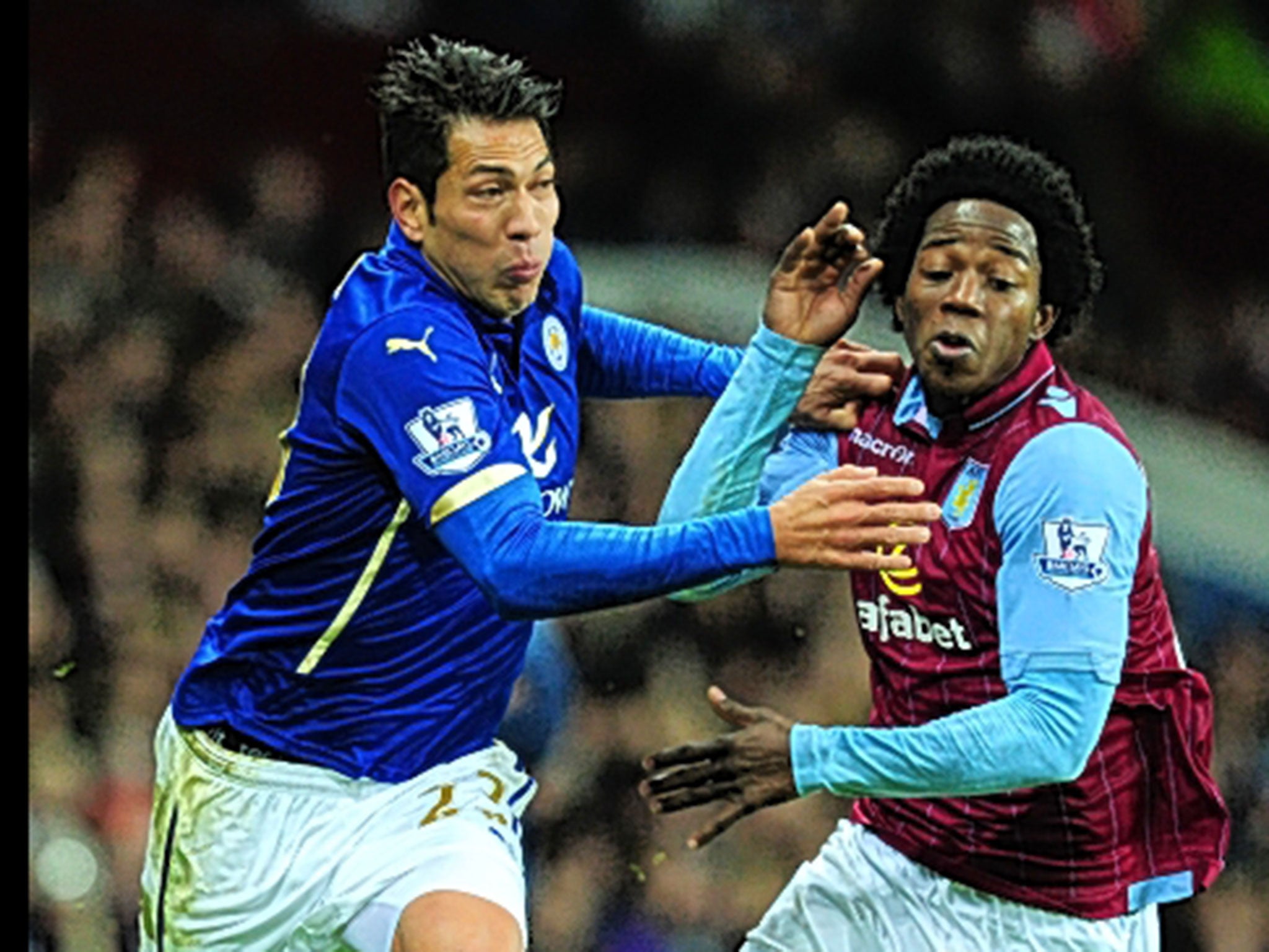 Sanchez battles Leicester's Leonardo Ulloa for the ball