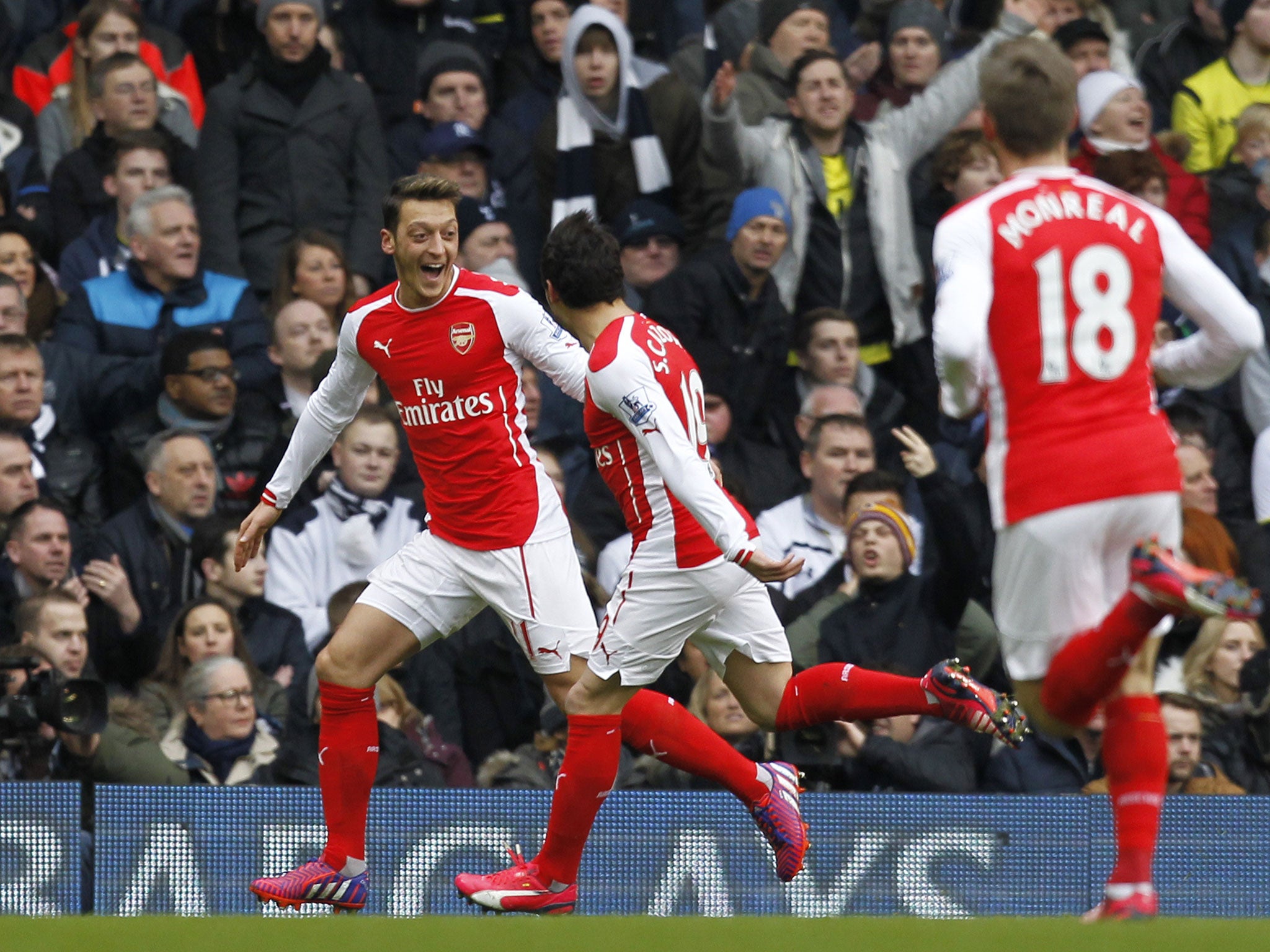 Mesut Ozil celebrates with Santi Cazorla after scoring against Spurs