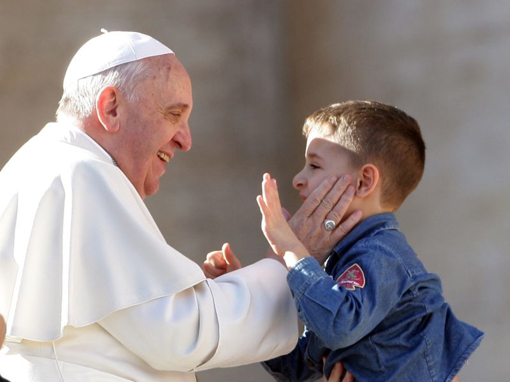 Smacking with dignity: Pope Francis greets a child last year