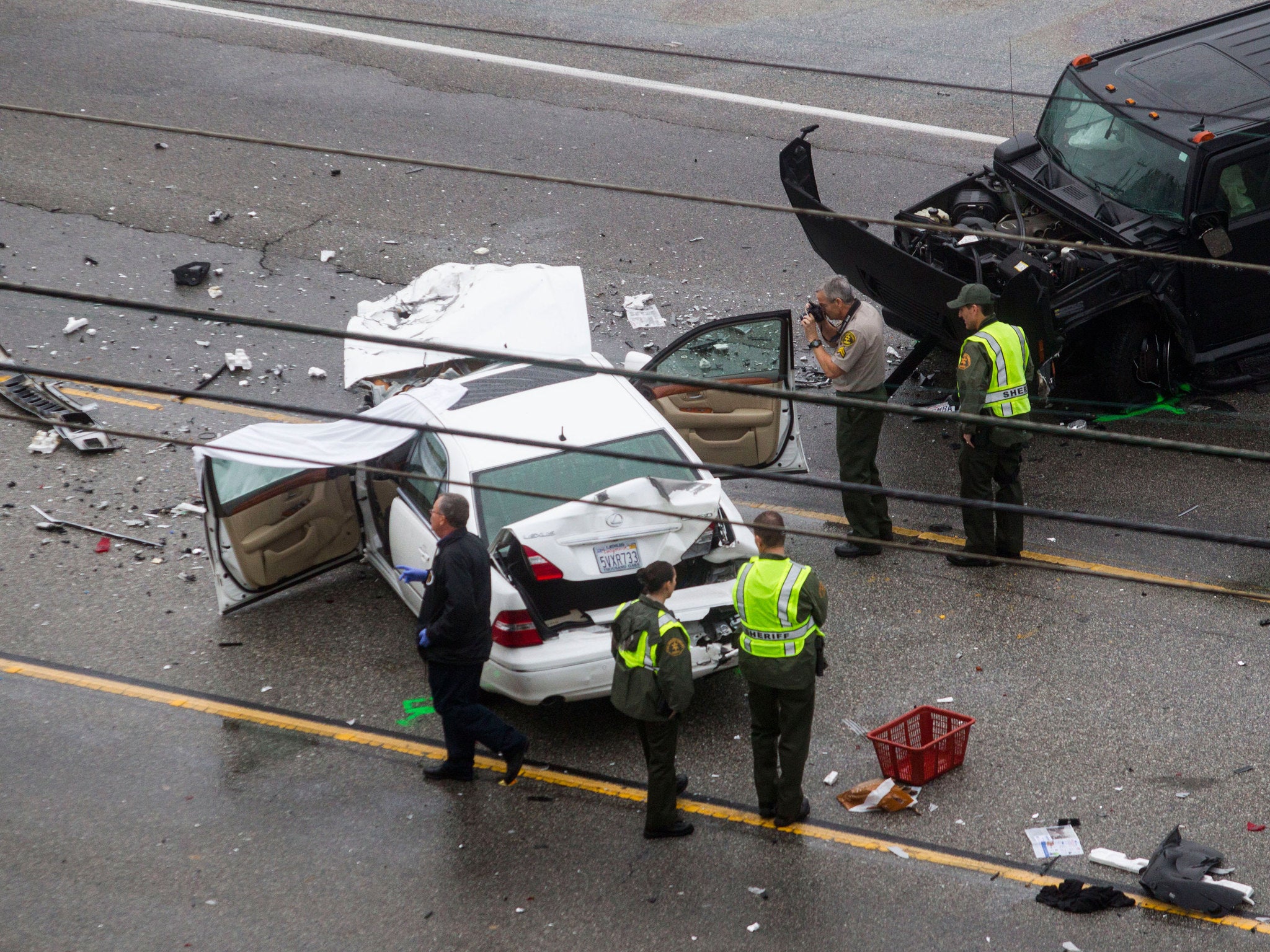 Los Angeles County Sheriff's deputies investigate the scene of the crash