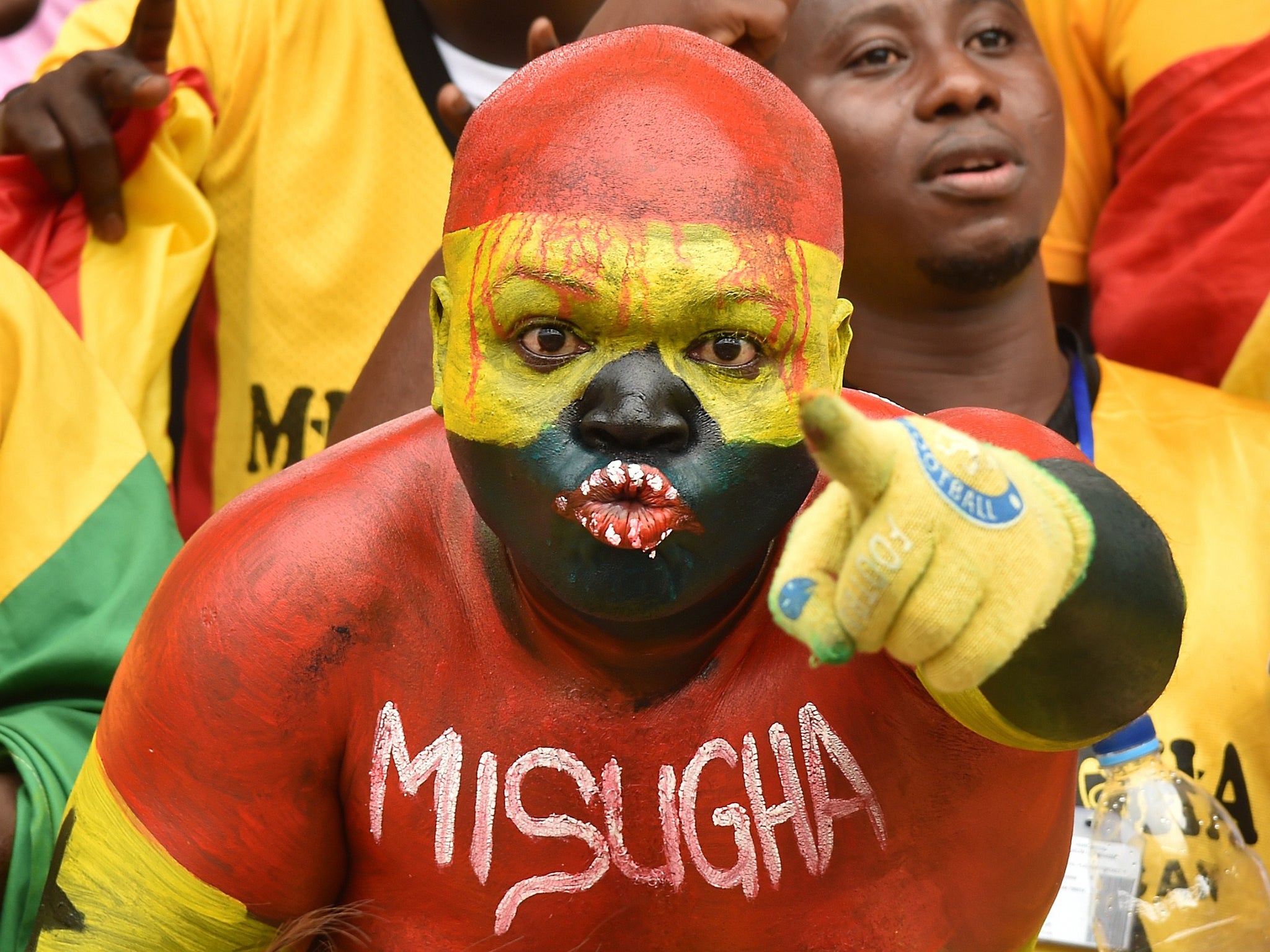 A Ghanaian fan cheers for his team