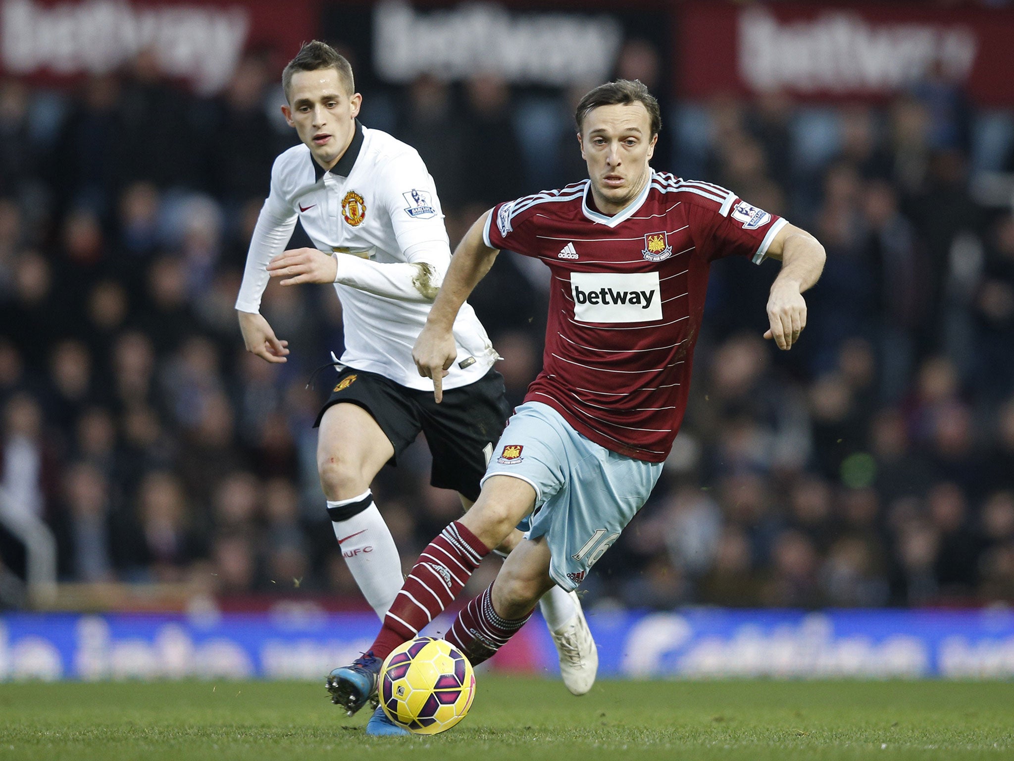 Mark Noble evades the challenge of Adnan Januzaj