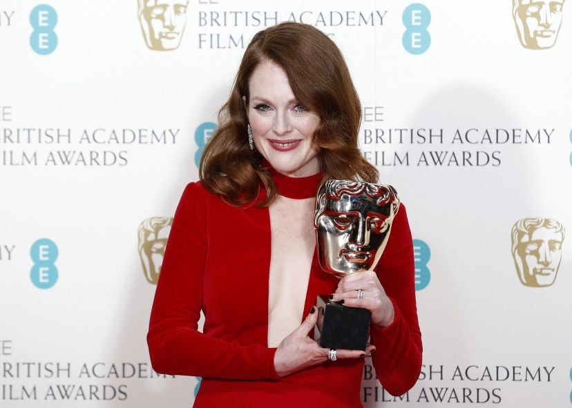 Actress Julianne Moore poses after receiving the award for best leading actress for "Still Alice"