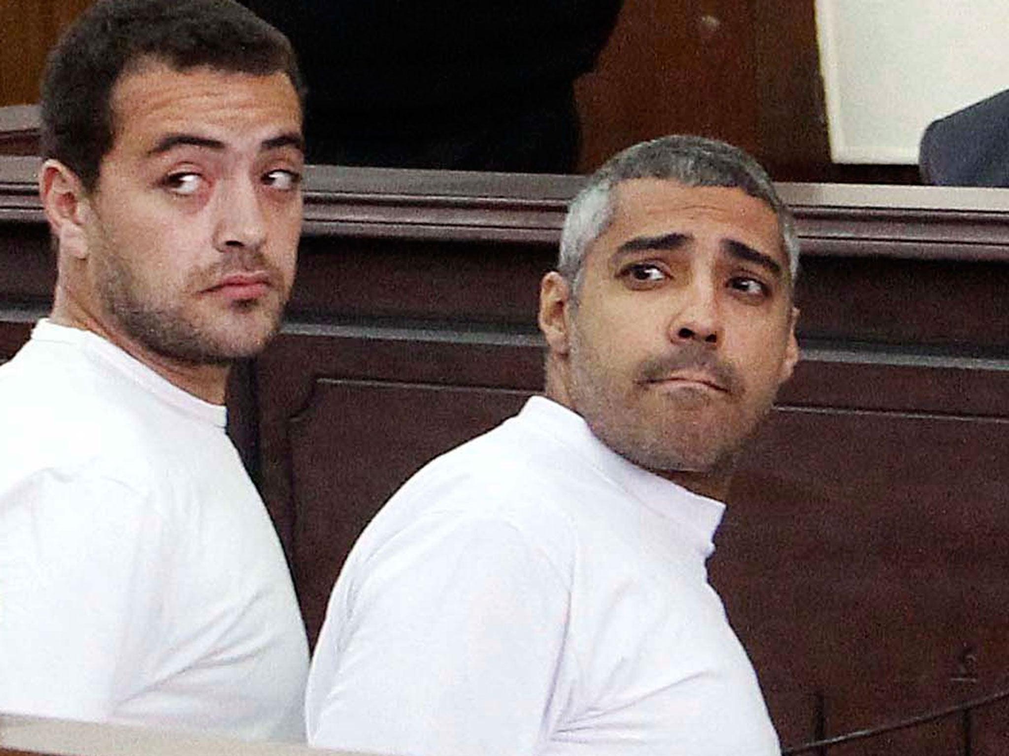 Al-Jazeera English producer Baher Mohamed, left, and Canadian-Egyptian acting Cairo bureau chief Mohammed Fahmy, right, during their previous appearance in court