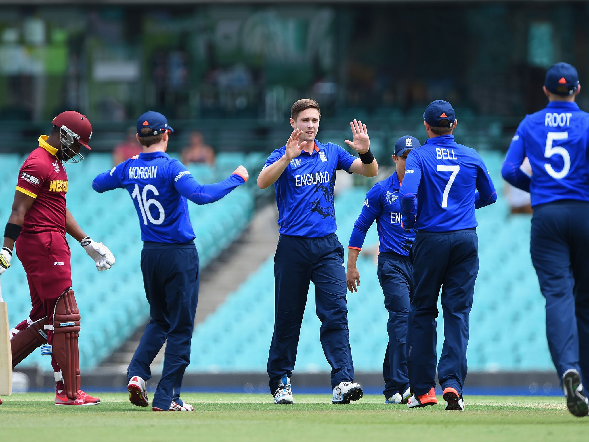 Chris Woakes celebrates taking the wicket of Darren Bravo