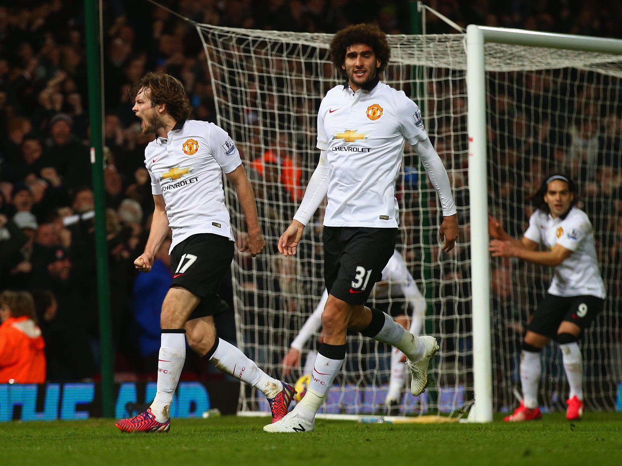 Daley Blind and Marouane Fellaini celebrate Manchester United's late goal against West Ham