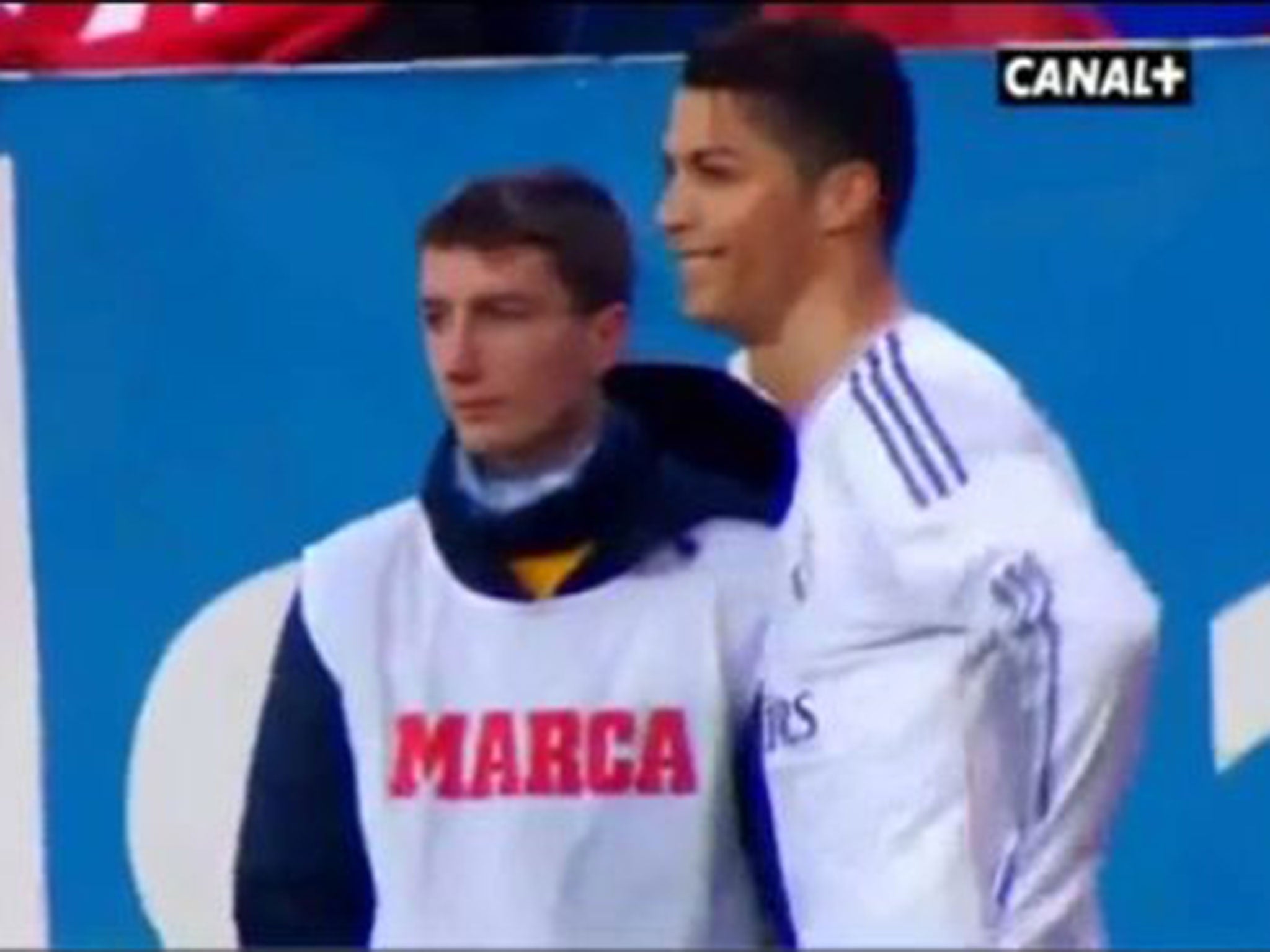 Cristiano Ronaldo laughs after a ball boy throws the ball away from him