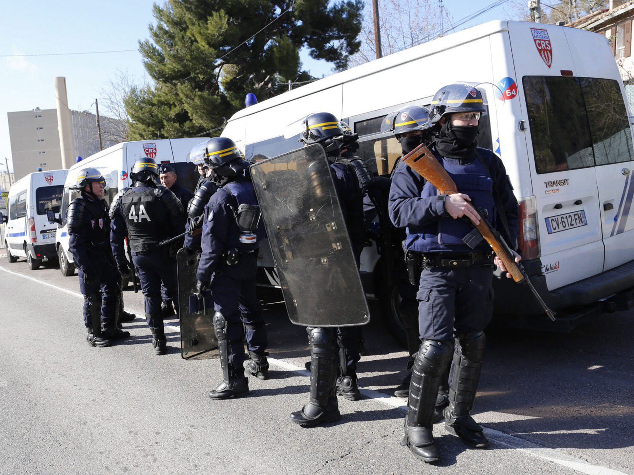 Members of the National Security forces (CRS) stand guard near the 'Cite de la Castellane' northern Marseille