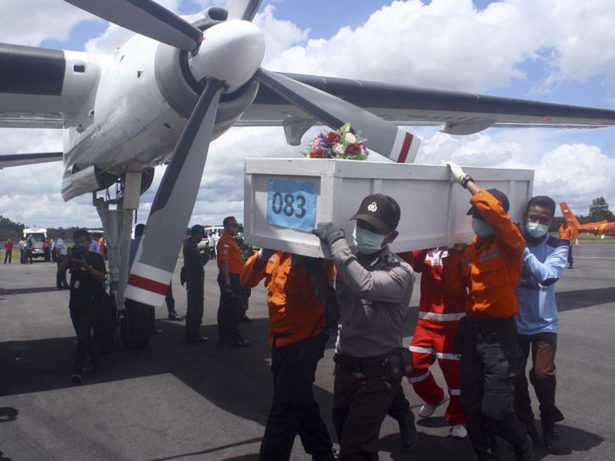 A coffin is moved containing recently recovered remains