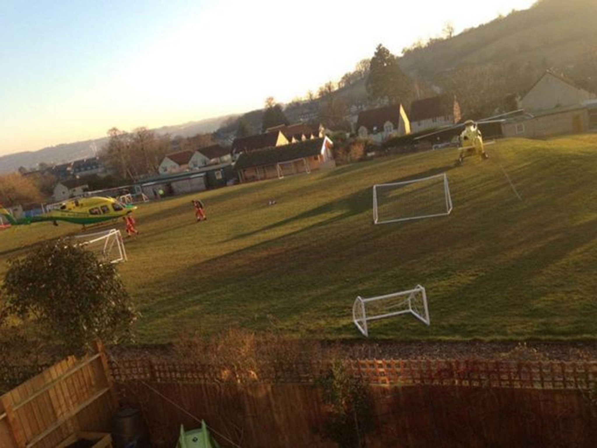 Two air ambulances attending near to the scene of an incident after a tipper truck collided with vehicles and pedestrians on a hill in Lansdown Lane