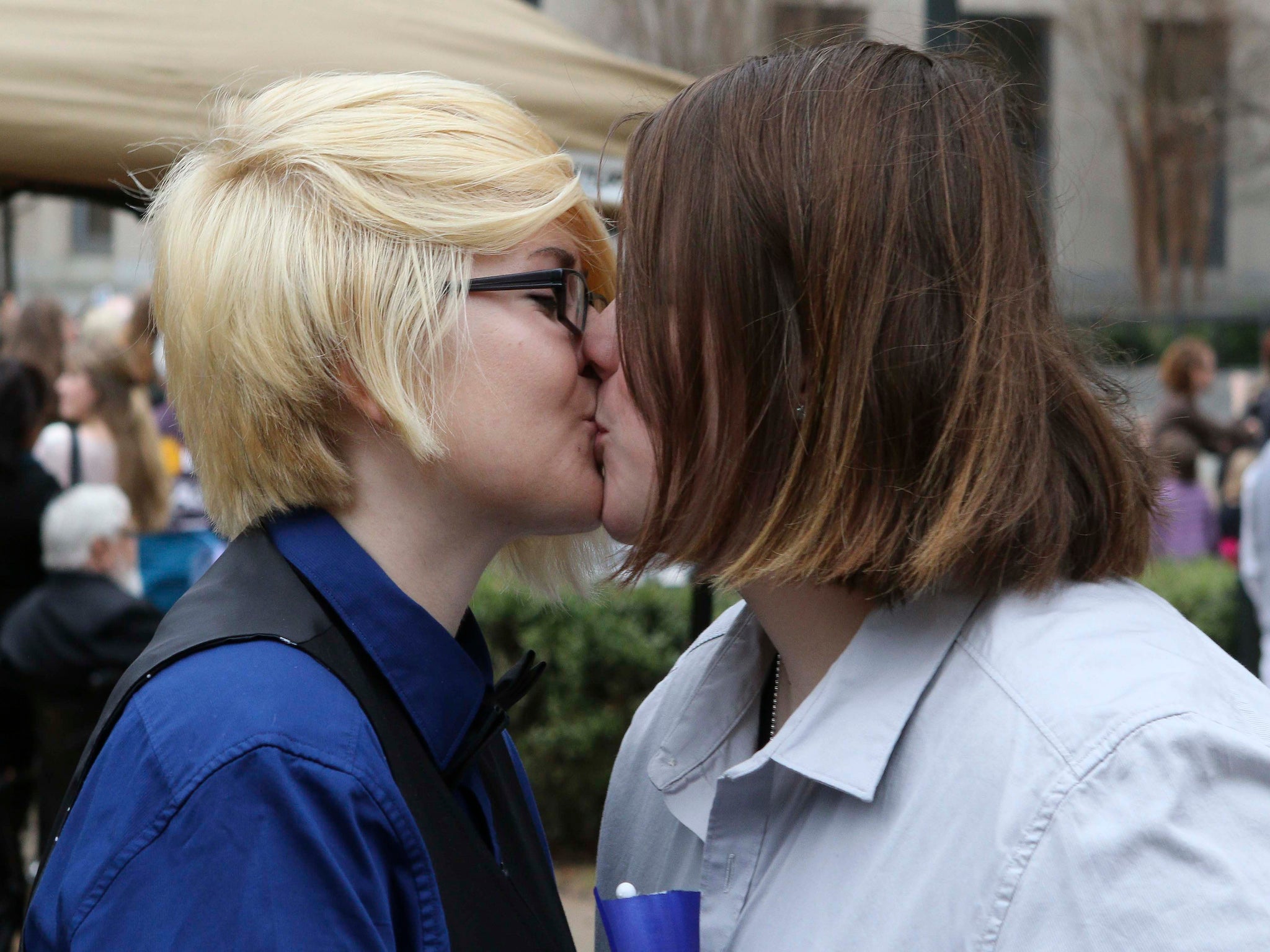 Britain Cook and Heather Bowling kiss after getting married in a park outside Jefferson County Courthouse in Birmingham, Alabama