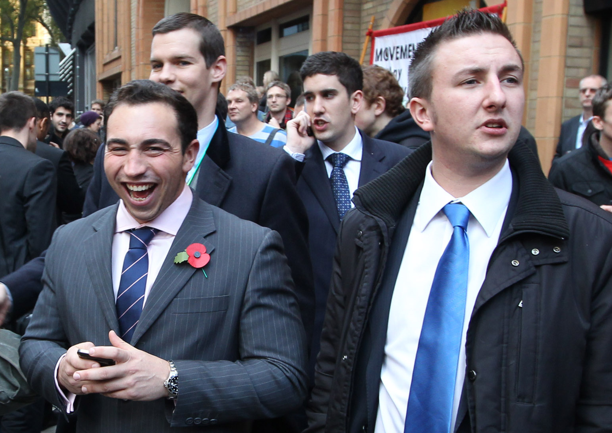 City workers smile as they stand in the street during a student demonstration against higher tuition fees and privatisation in universities