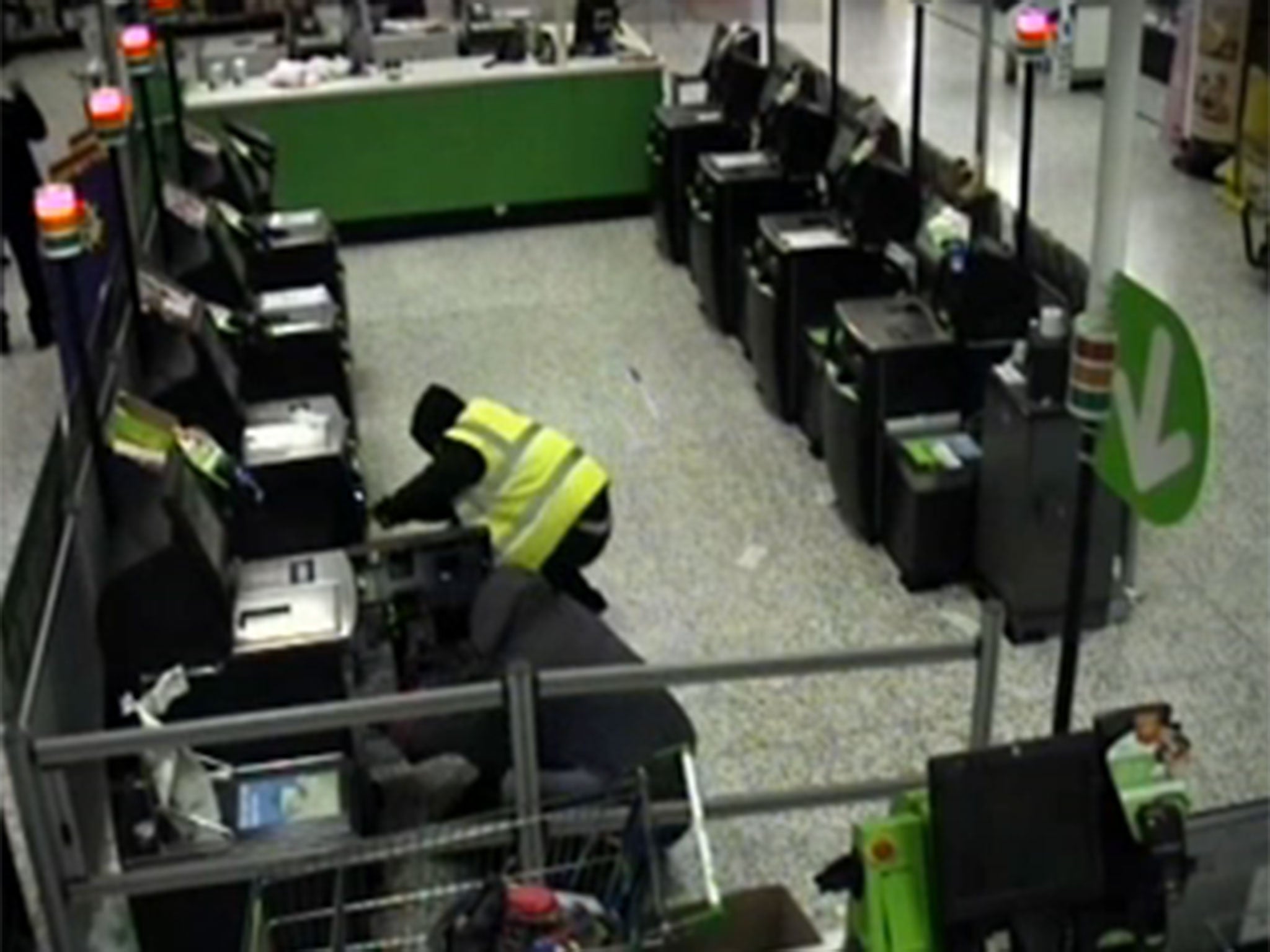 Four men breaking open the self-service machines