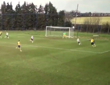 Brooklyn Beckham (right) strikes the ball for Arsenal