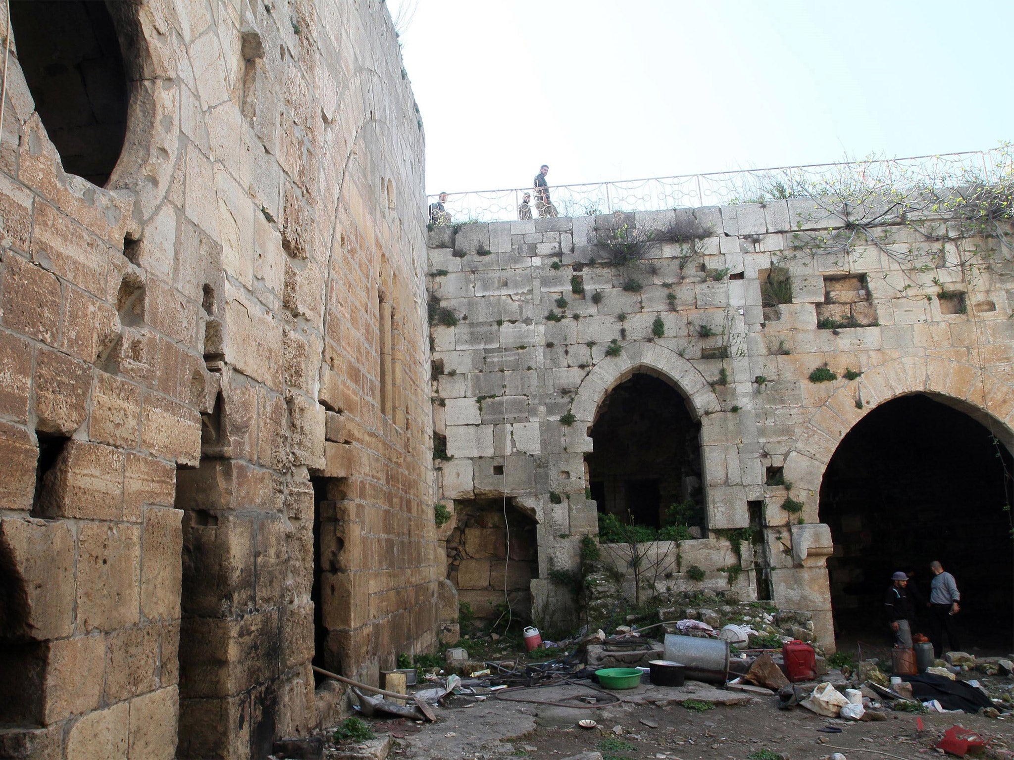 Syrian troops inspect items left by rebel fighters in the Crac de Chevaliers, near Homs (Getty)